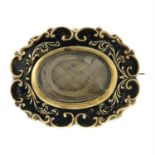 An early 19th century enamel and woven hair mourning brooch.