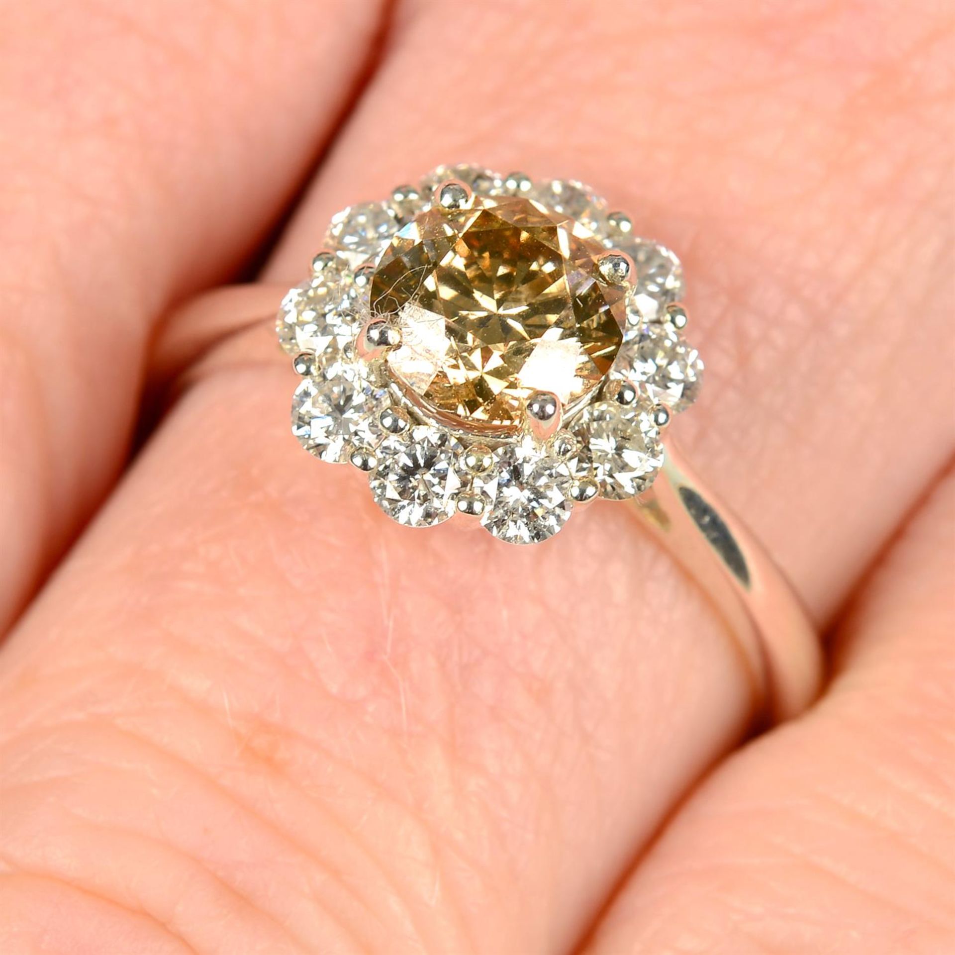 An 18ct gold 'brown' diamond and diamond cluster ring.