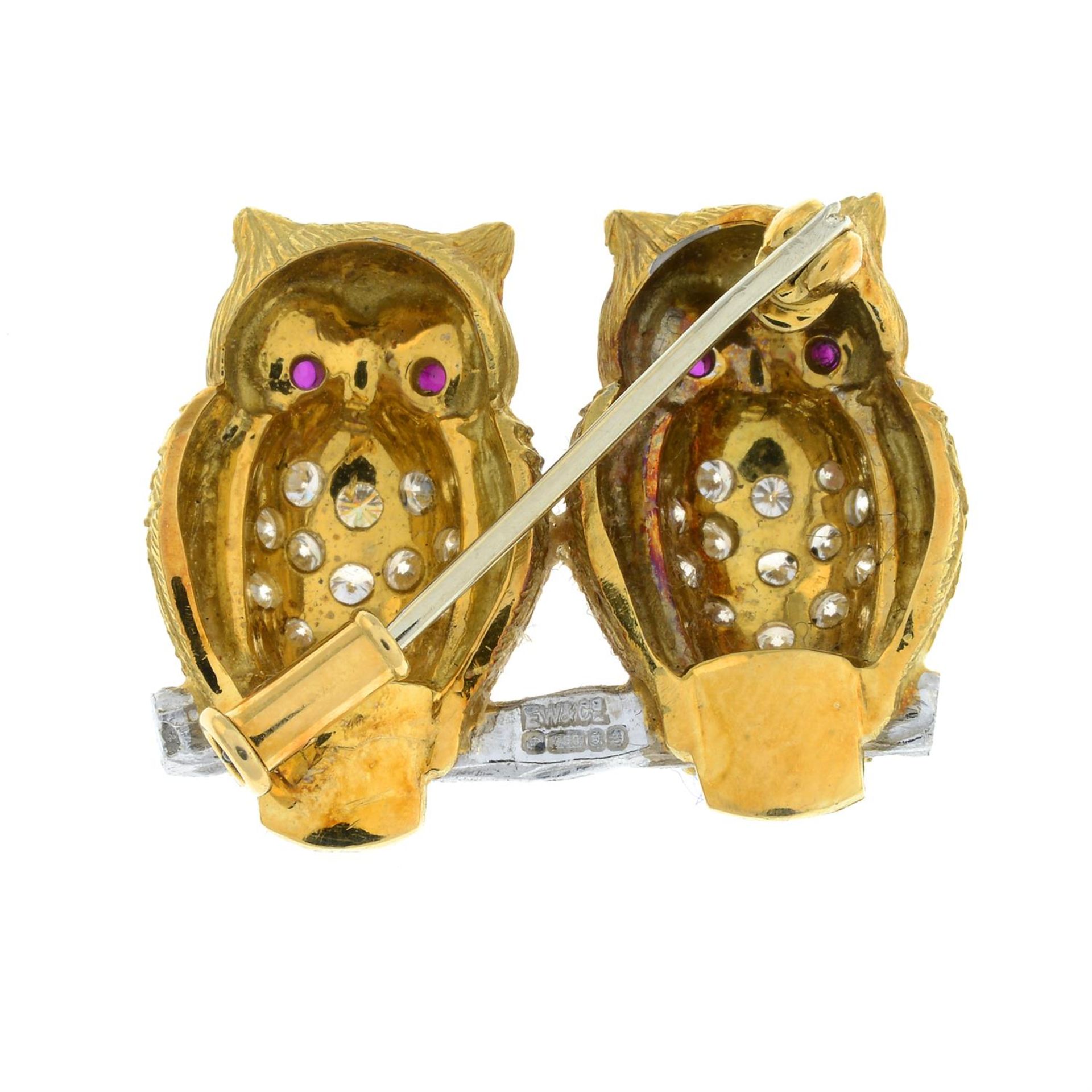 A bi-colour 18ct gold brilliant-cut diamond brooch, depicting a pair of owls, with ruby eyes, by E. - Image 3 of 4