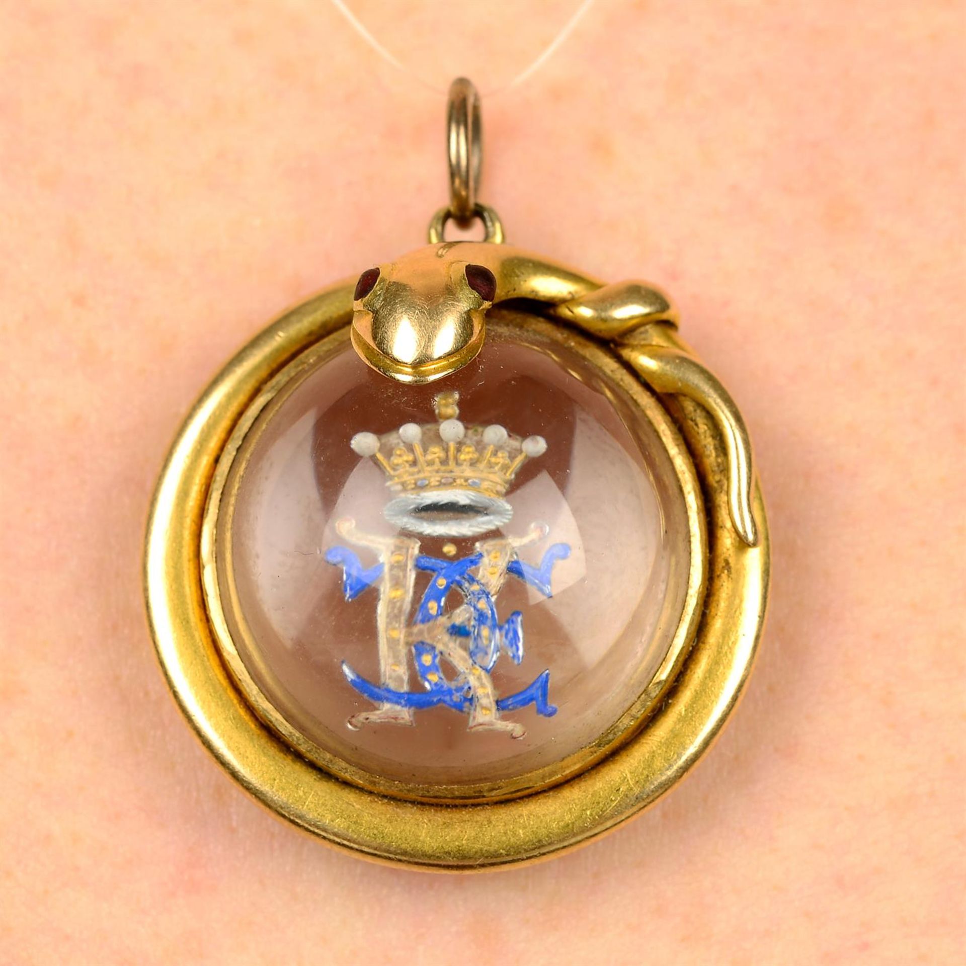 A late 19th century 18ct gold snake locket, the rock crystal reverse carved and painted with