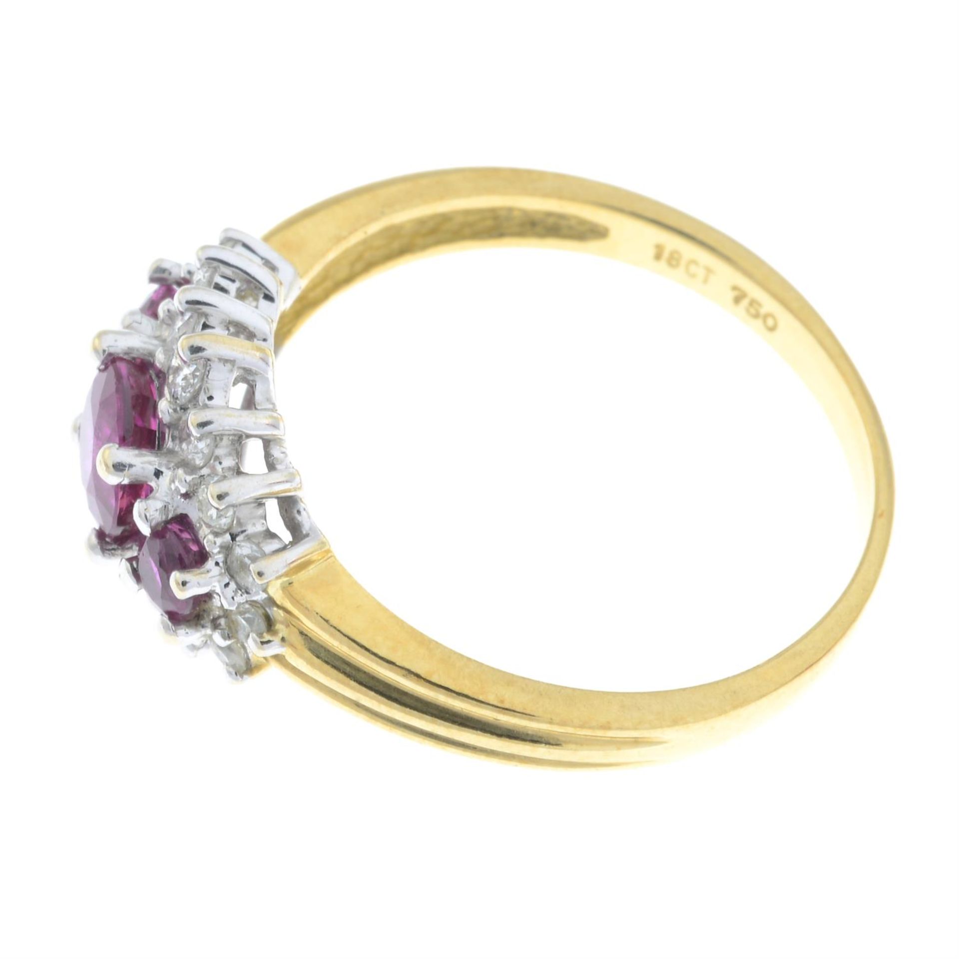 An 18ct gold graduated ruby three-stone ring, with brilliant-cut diamond surround. - Image 4 of 5