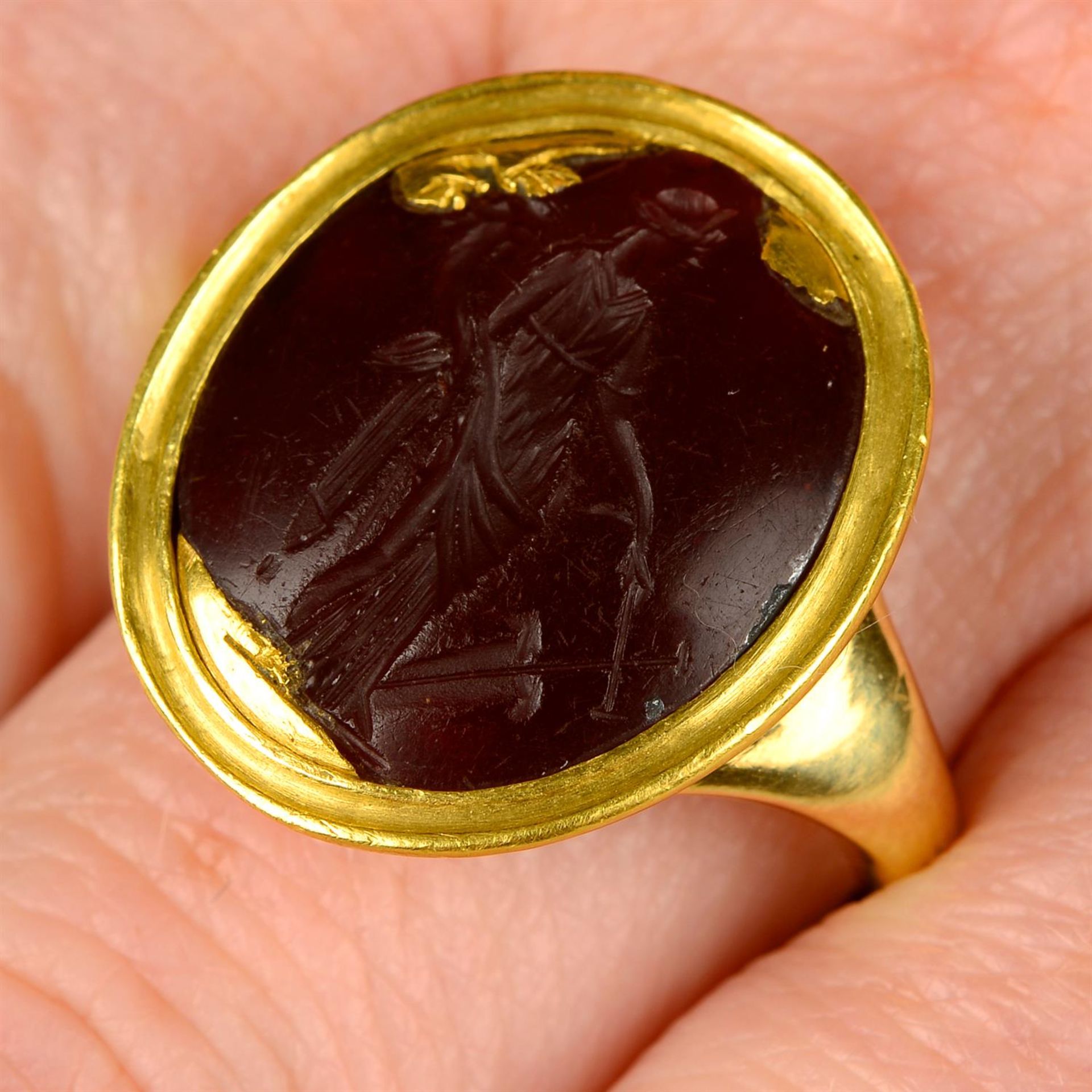A Roman 1st century carnelian intaglio, in later 18ct gold ring mount, possibly carved to depict
