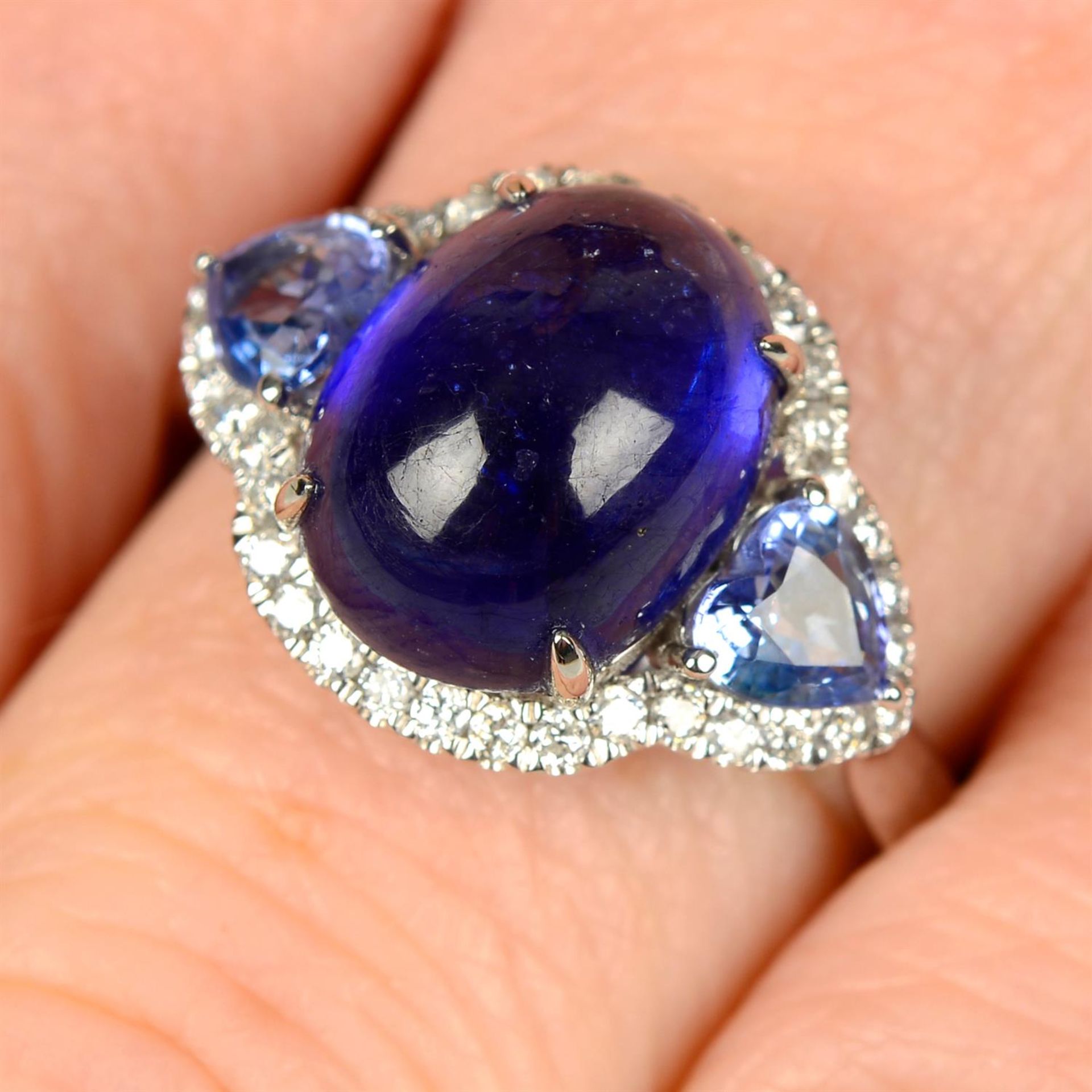 A glass-filled sapphire cabochon, heart-shape sapphire and brilliant-cut diamond dress ring.