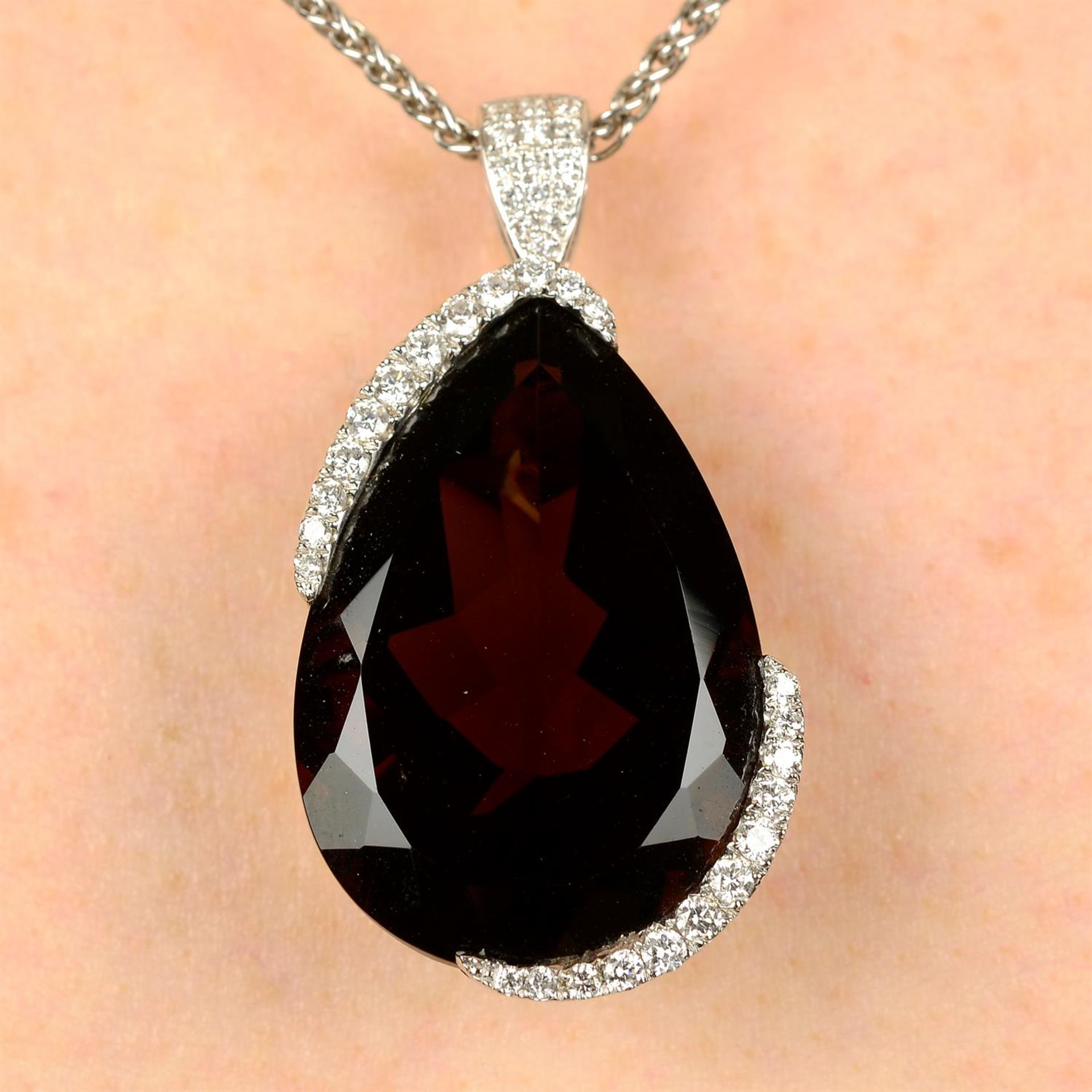 A smokey quartz and diamond pendant, with 18ct gold chain.