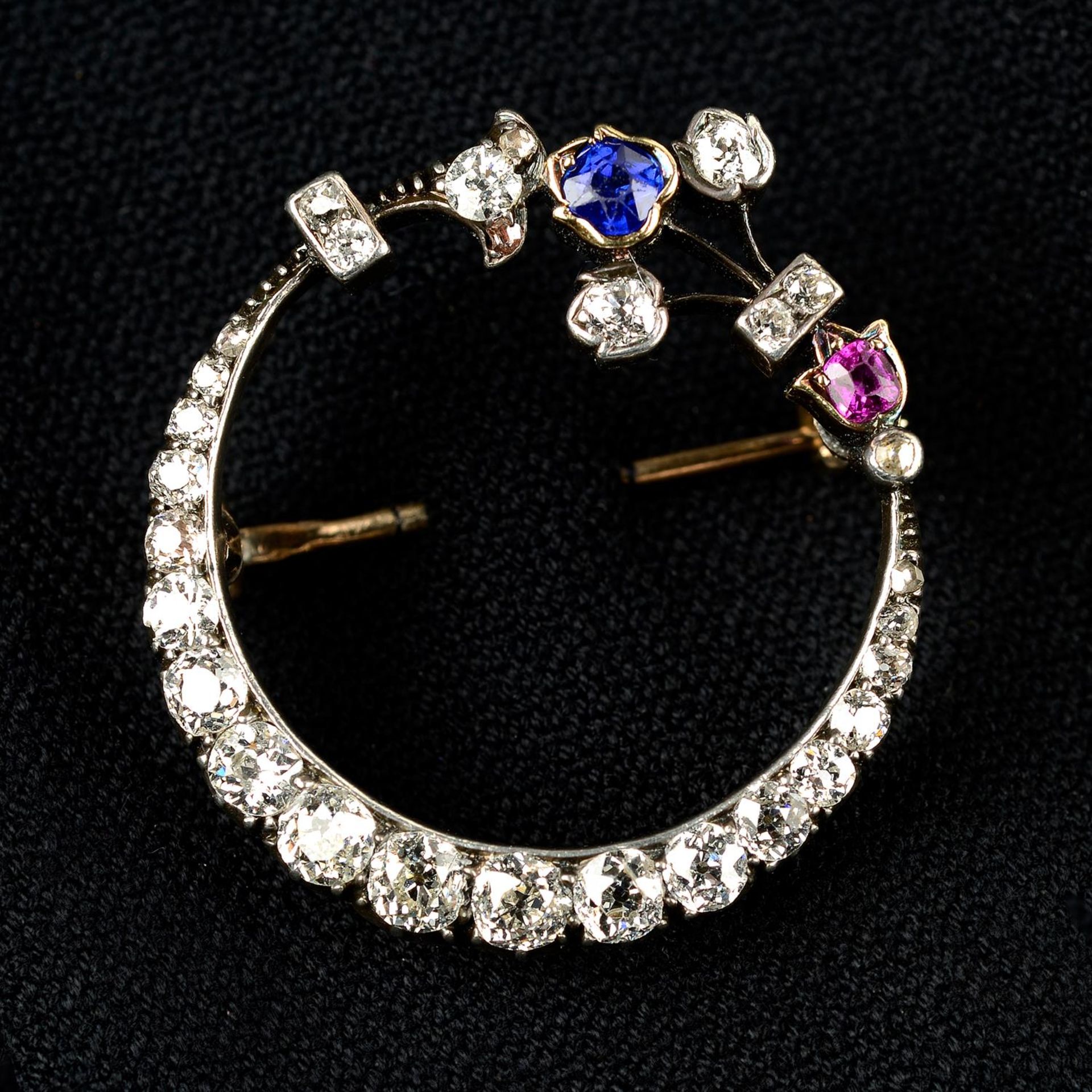 A late 19th century silver and gold, old-cut diamond, sapphire and ruby crescent brooch.