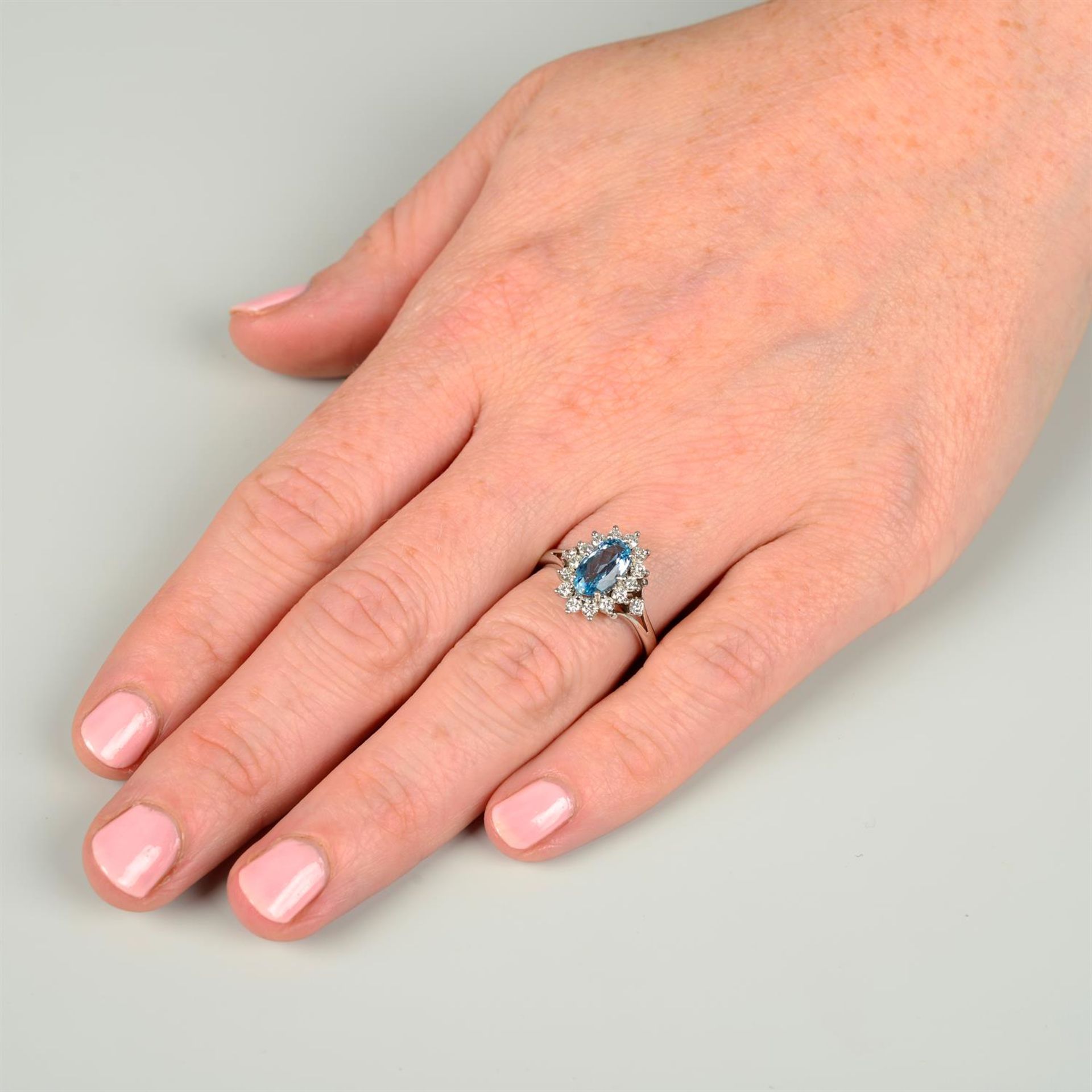 A platinum, aquamarine and brilliant-cut diamond cluster ring. - Image 5 of 5