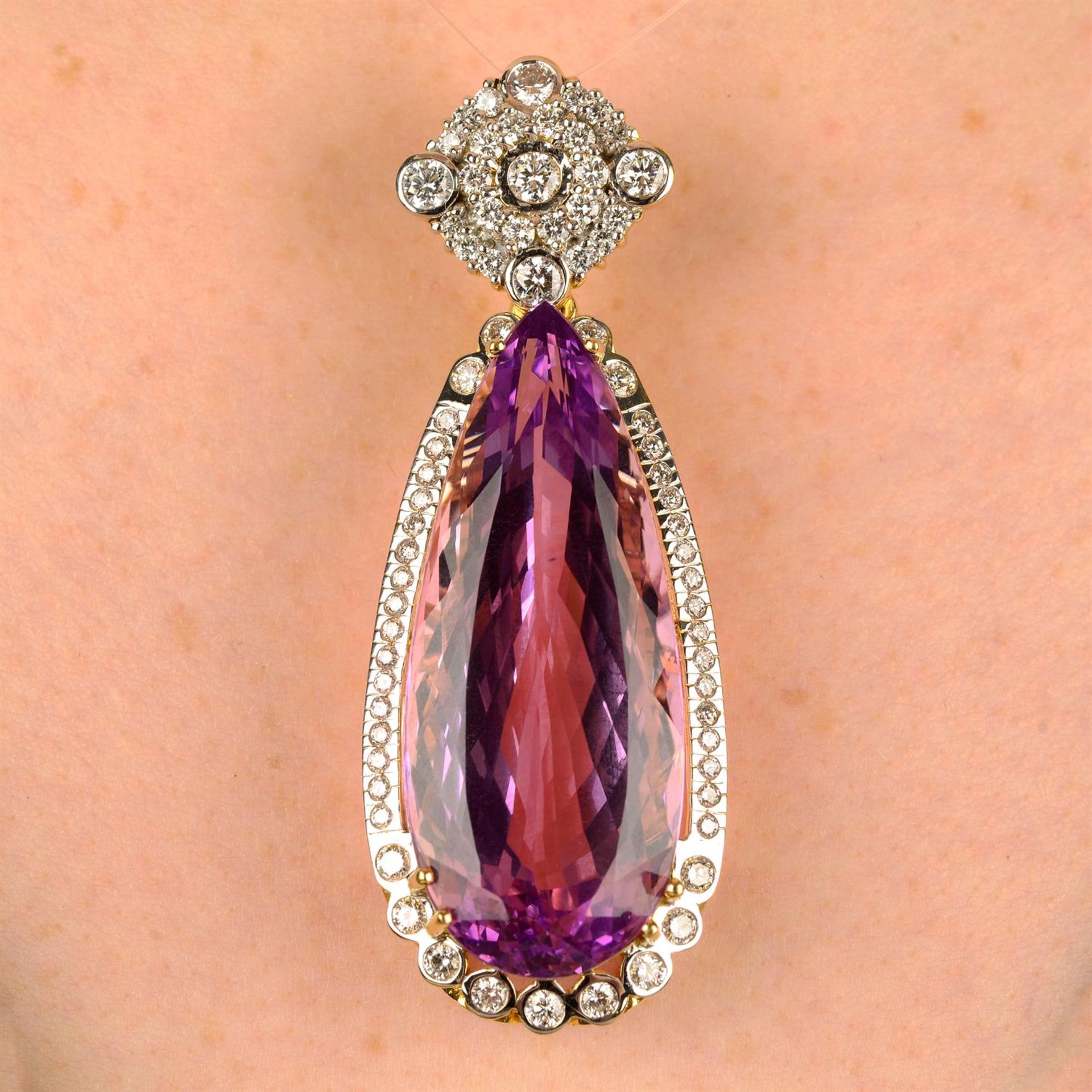 A kunzite and diamond pendant.