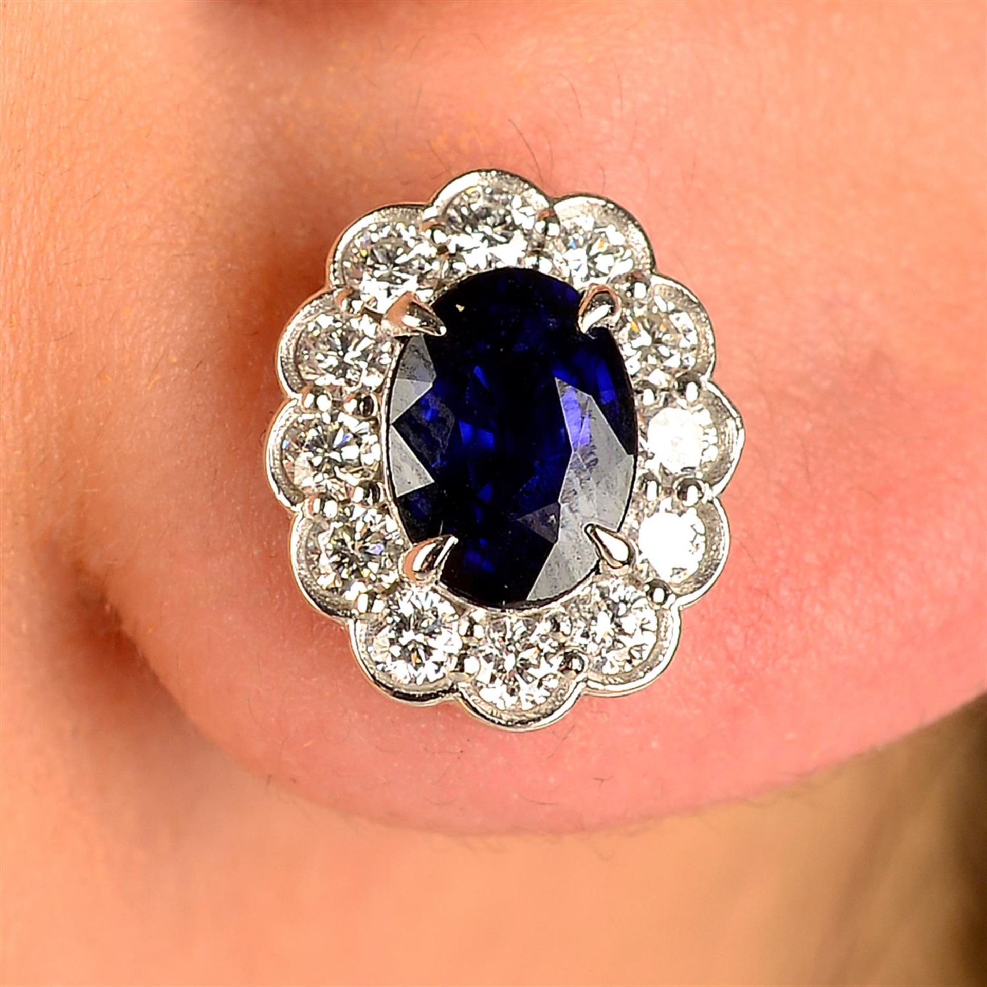 A pair of sapphire and diamond cluster earrings.