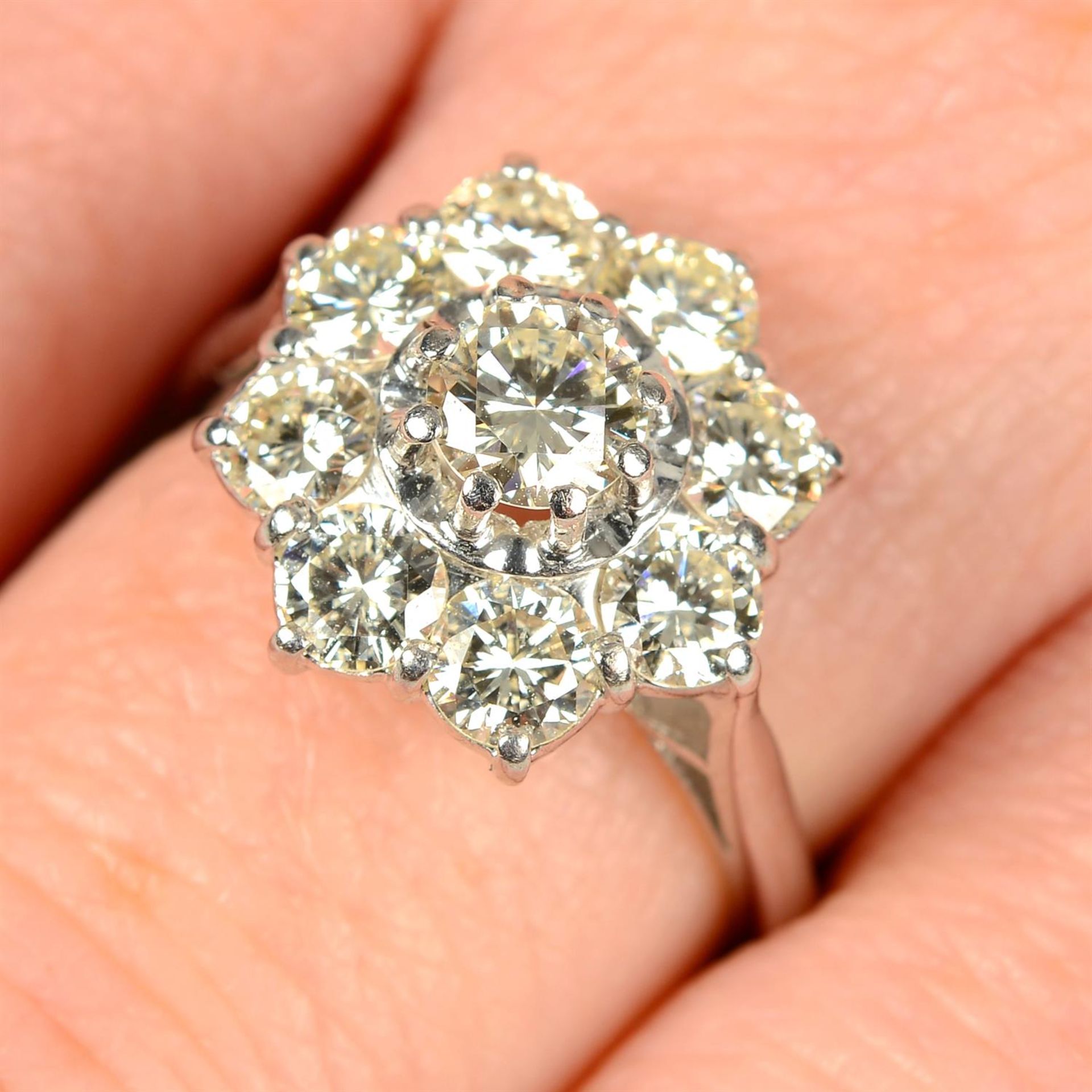 A brilliant-cut diamond cluster ring.