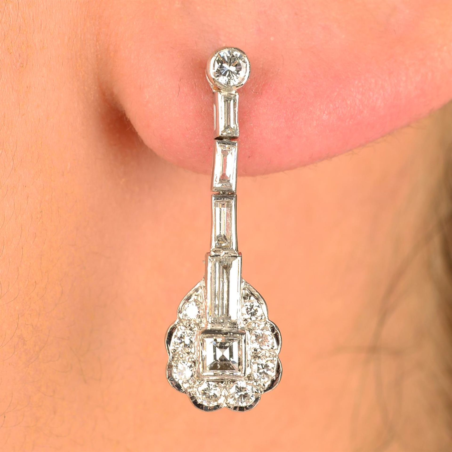 A pair of vari-cut diamond earrings.