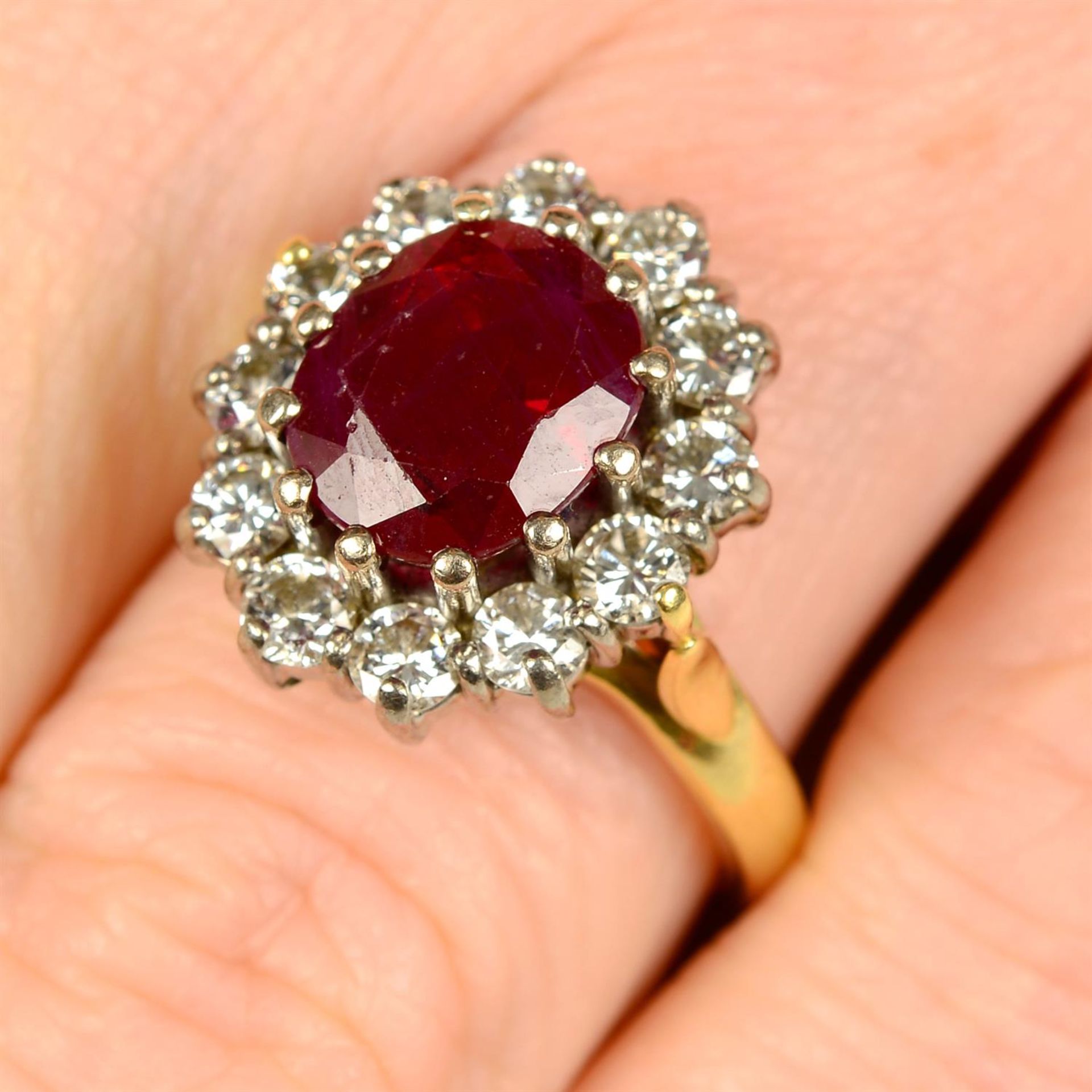 An 18ct gold ruby and brilliant-cut diamond cluster ring.