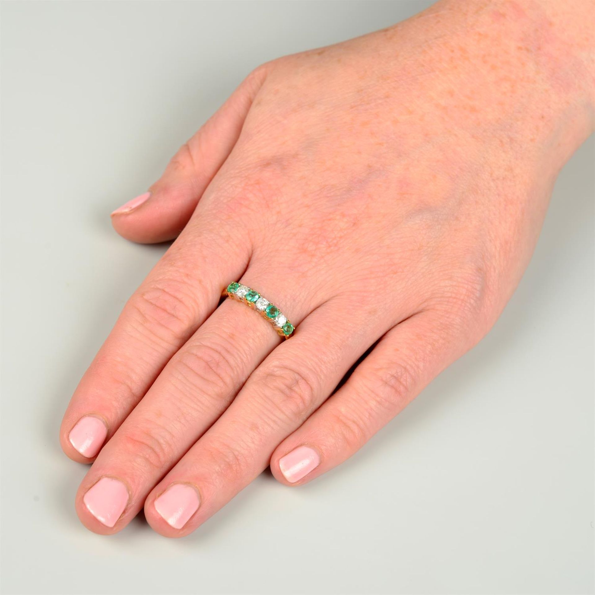 An 18ct gold alternating emerald and brilliant-cut diamond line ring. - Image 5 of 5