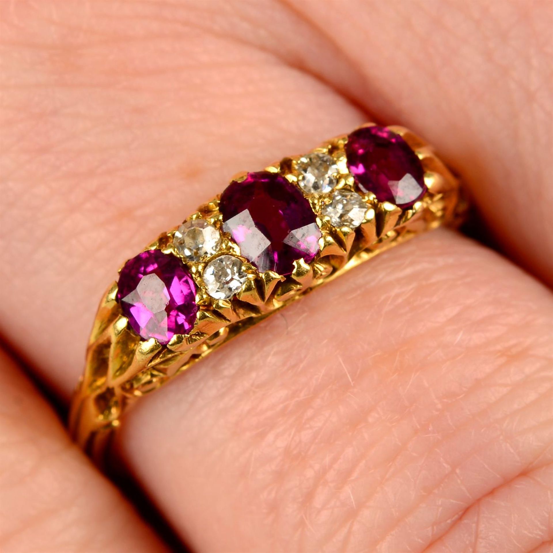 An Edwardian 18ct gold ruby three-stone and diamond ring.