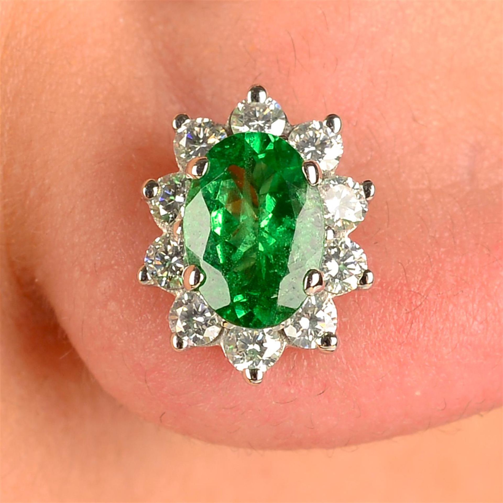 A pair of green garnet and brilliant-cut diamond cluster earrings.