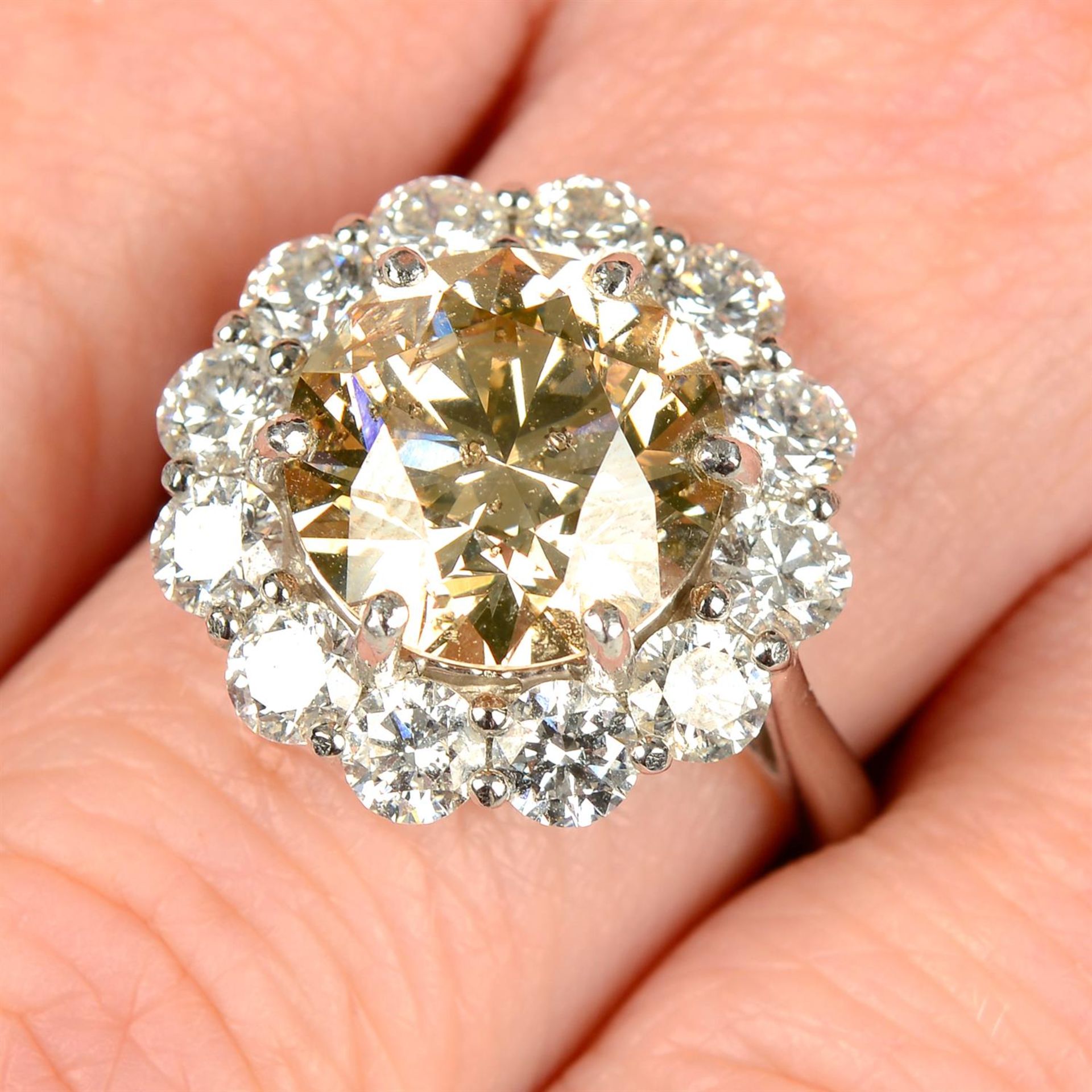 A platinum 'brown' diamond and brilliant-cut diamond cluster ring.