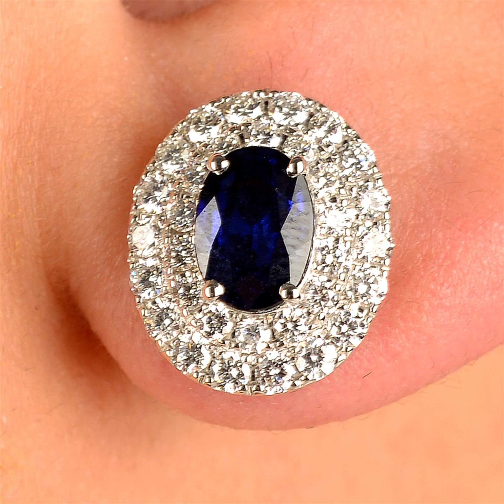 A pair of sapphire and brilliant-cut diamond cluster earrings.