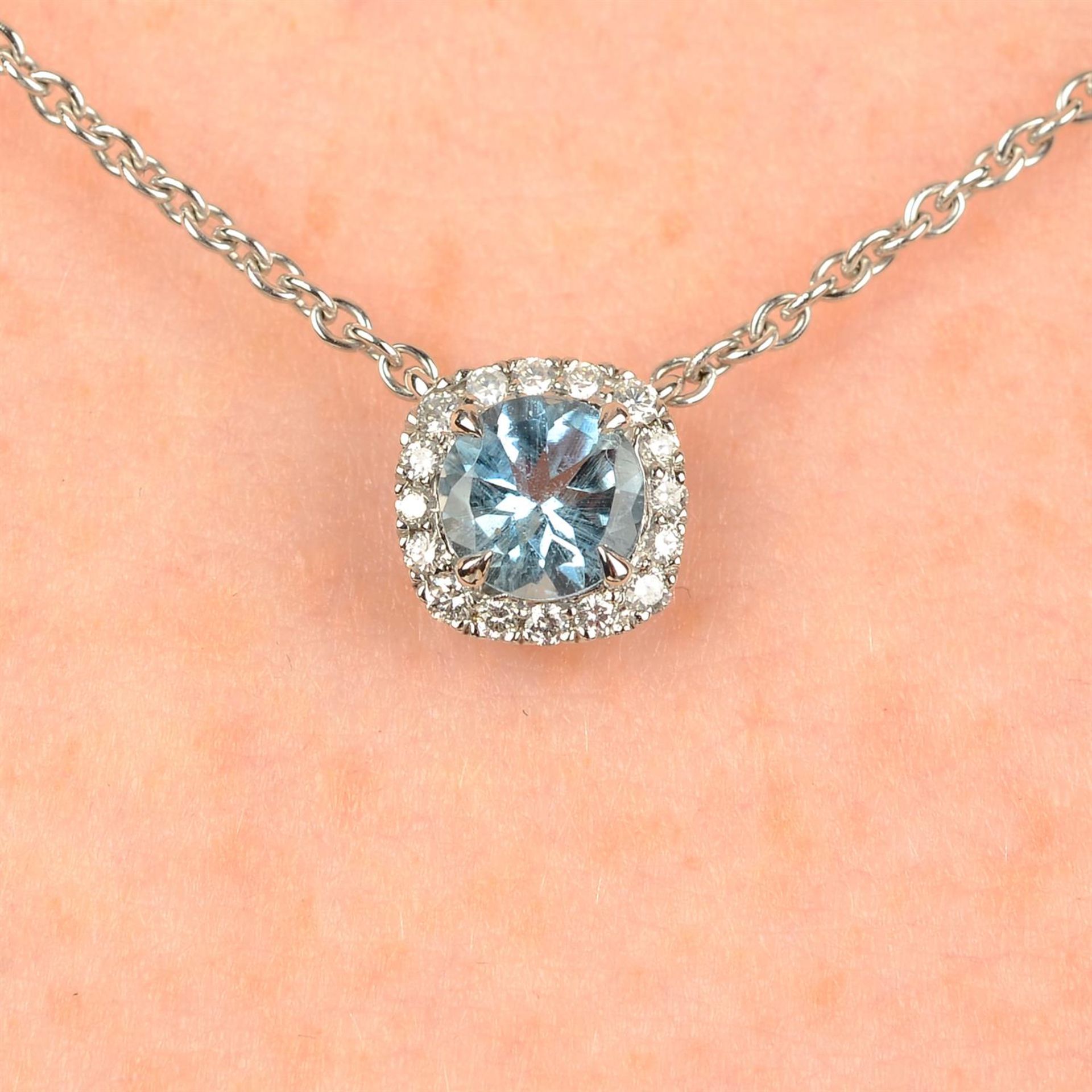 An 18ct gold aquamarine and brilliant-cut diamond pendant, on chain, by Garrard & Co Ltd.