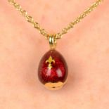 A red enamel and gilt fleur-de-lis egg pendant, on chain, by Fabergé.