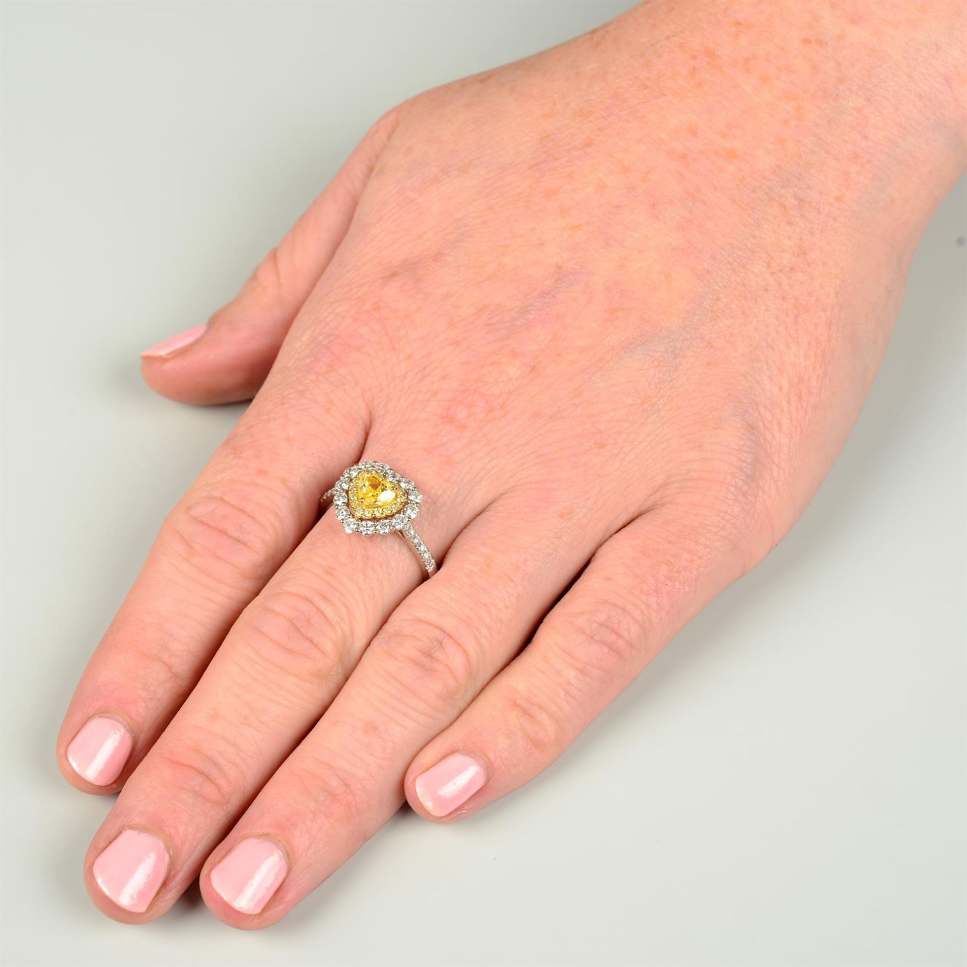 An 18ct gold Fancy Intense Yellow heart-shape diamond, 'yellow' diamond and diamond cluster ring. - Image 5 of 6