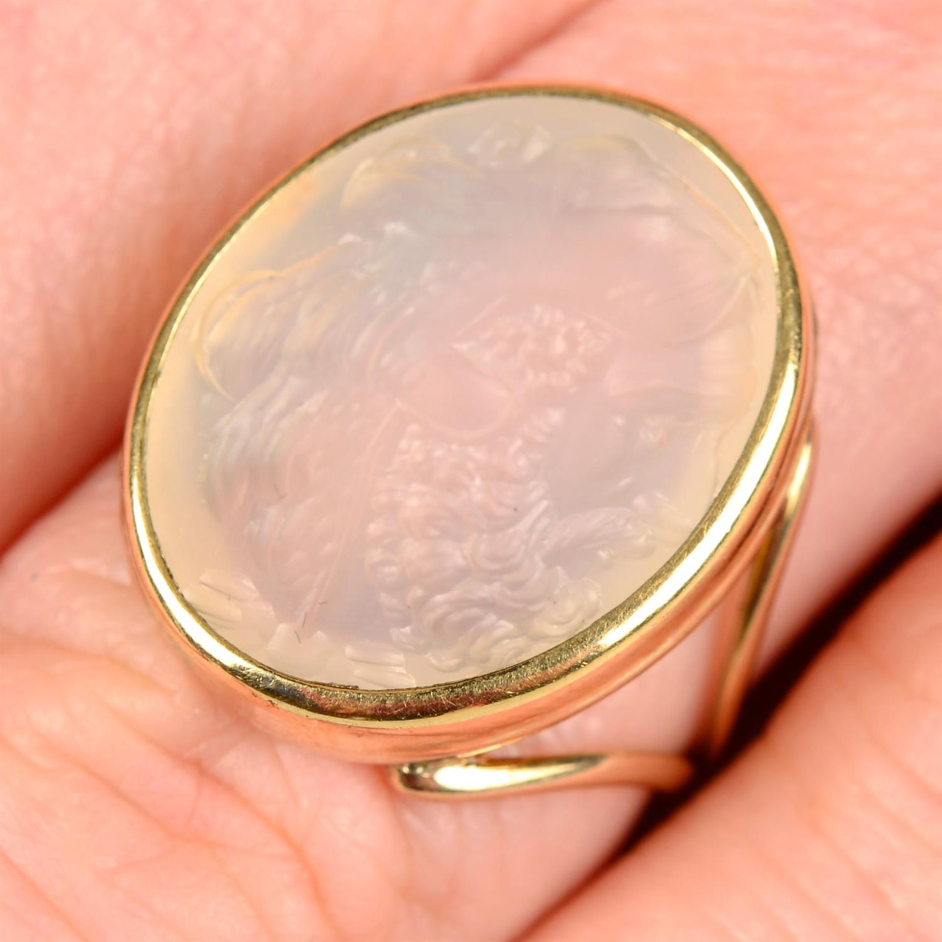 A chalcedony intaglio ring, carved to depict Hercules wearing the Nemean lion pelt.
