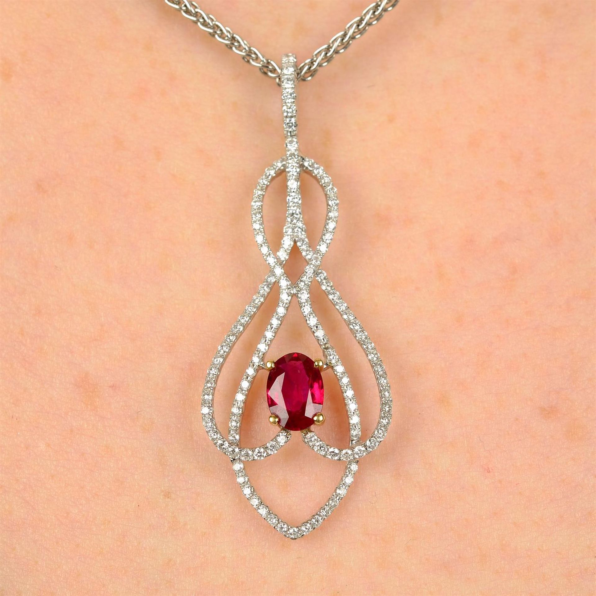 An 18ct gold ruby and diamond pendant, with chain.