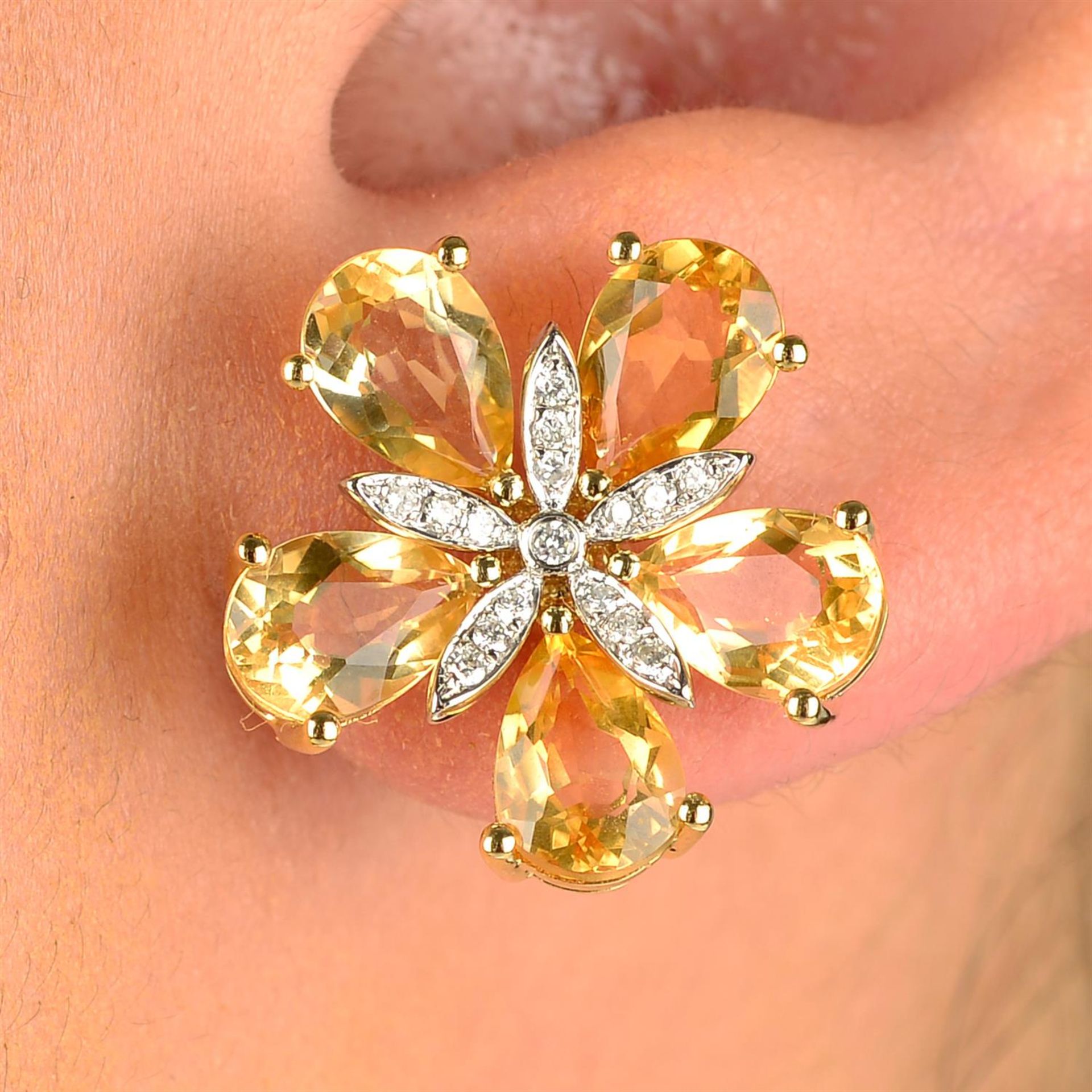 A pair of citrine and brilliant-cut diamond floral earrings.