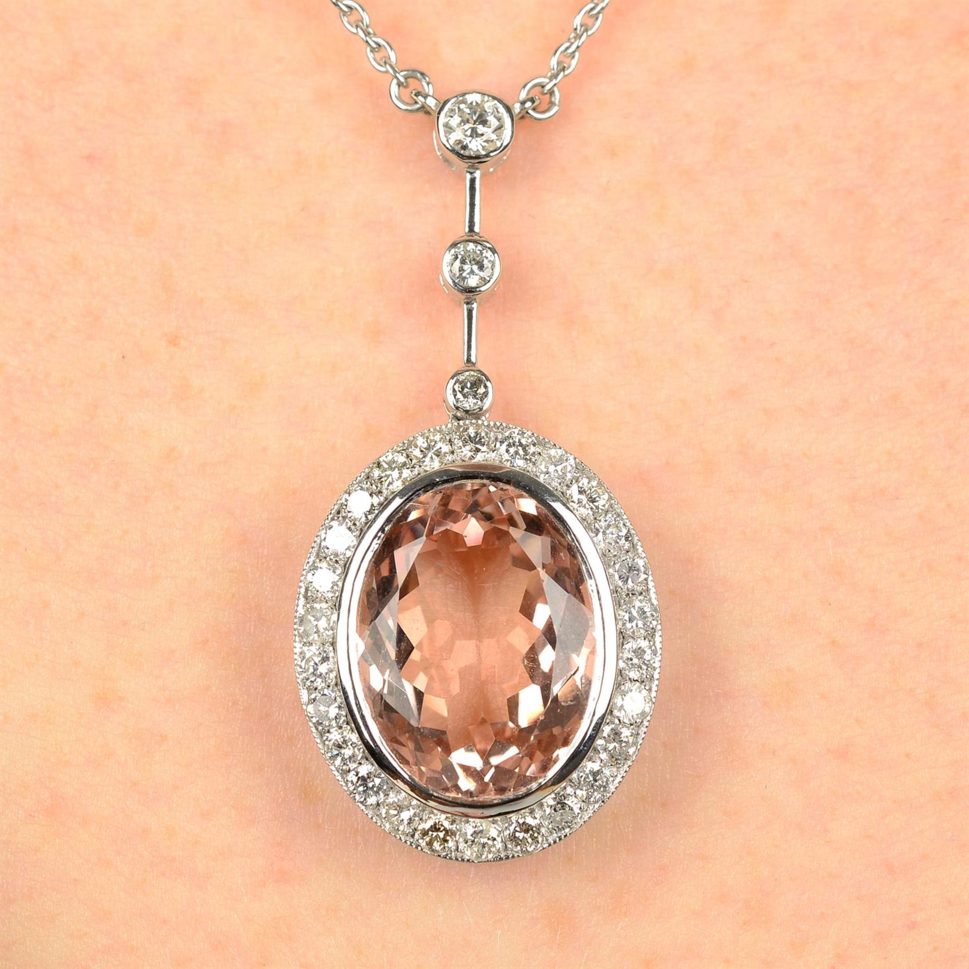 A morganite and diamond cluster pendant, on chain.