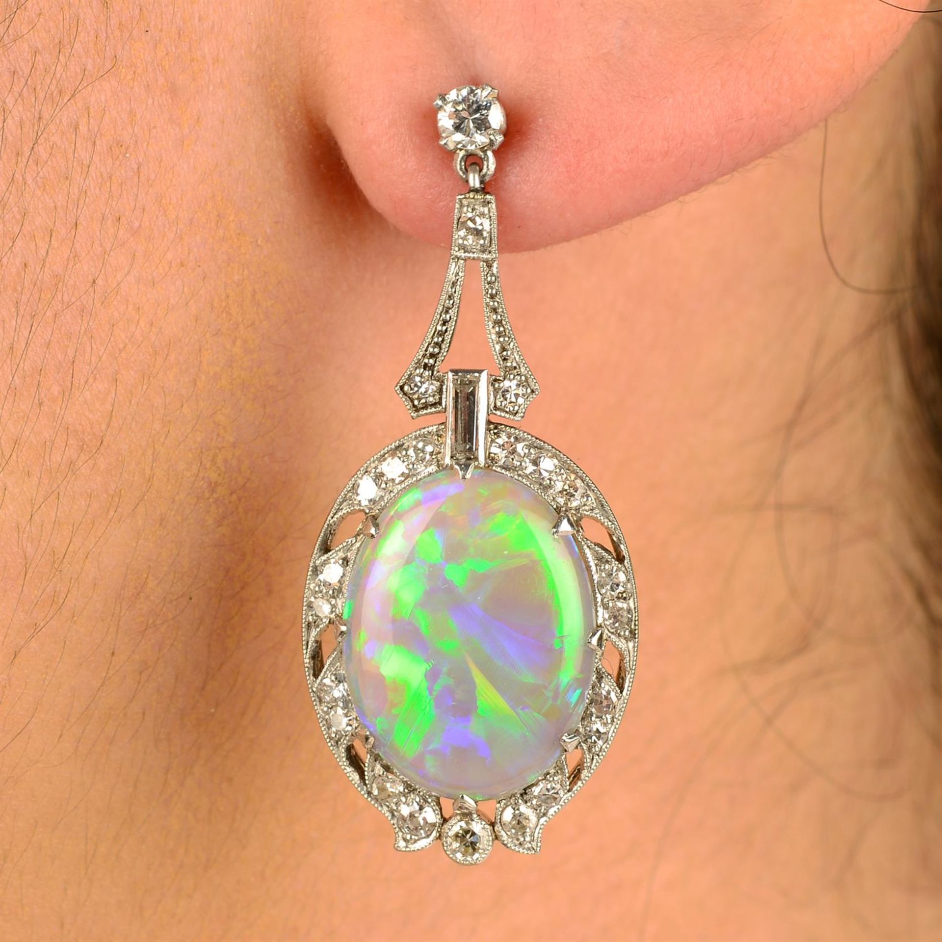 A pair of early 20th century platinum and 18ct gold opal and vari-cut diamond earrings.