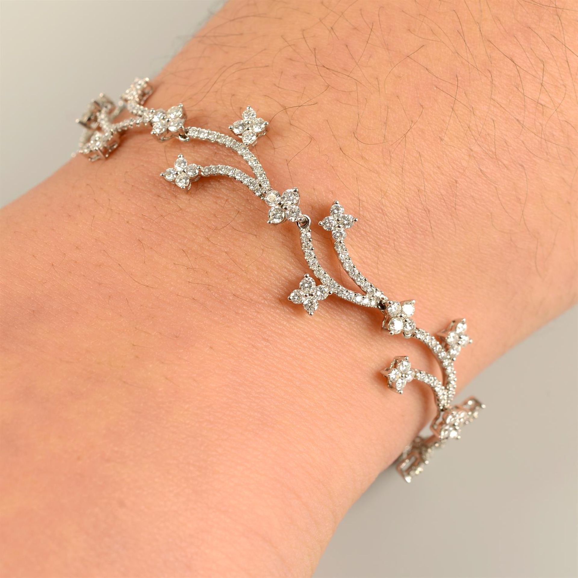 An 18ct gold brilliant-cut diamond floral bracelet.