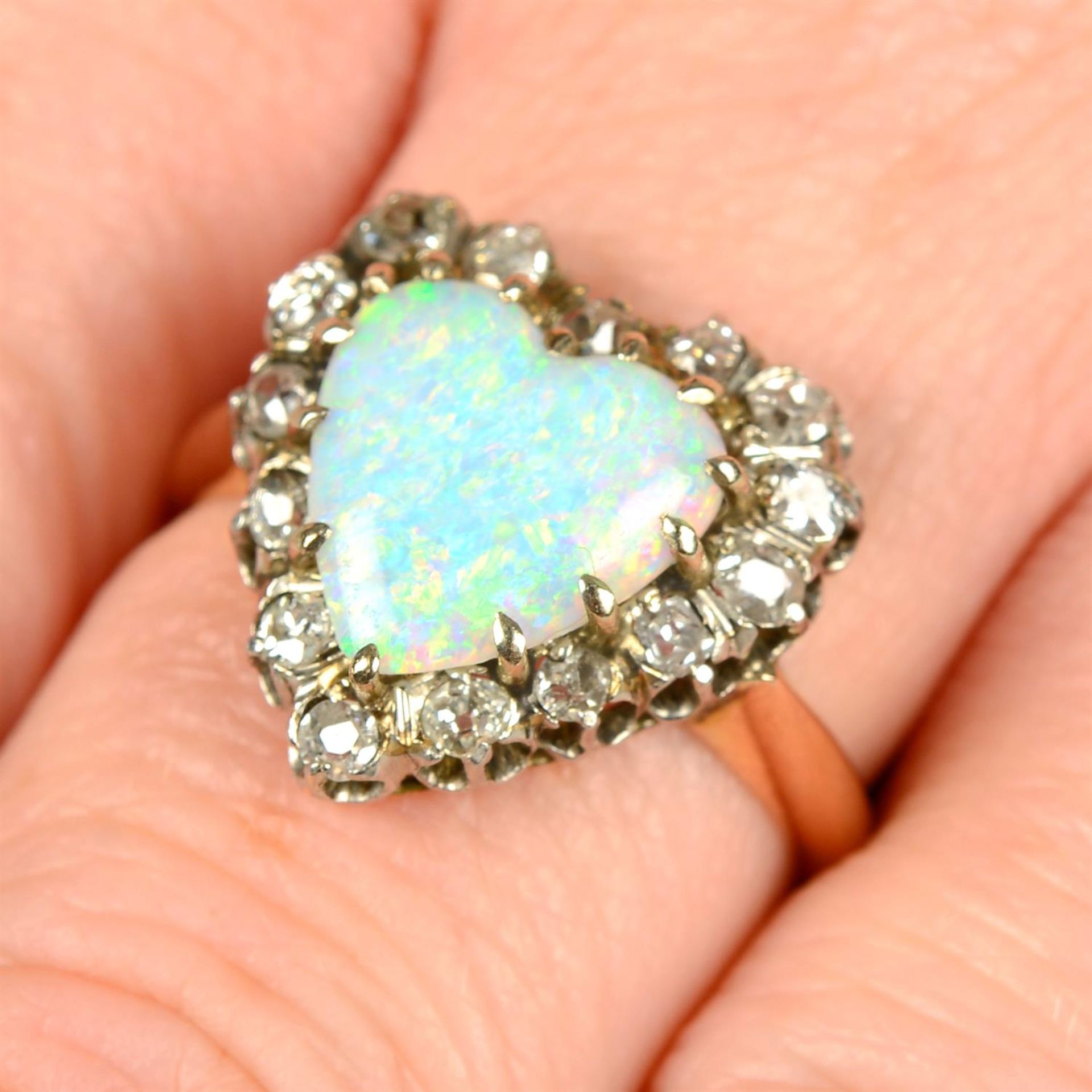 A mid 20th century platinum and 18ct gold heart-shape opal and old-cut diamond cluster ring.