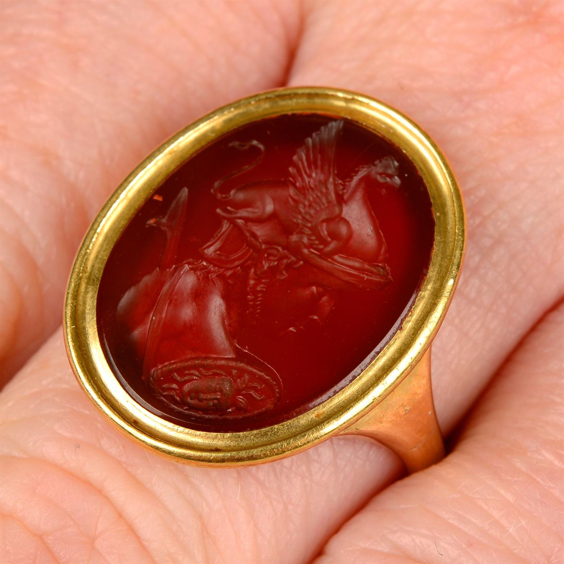 A 19th century gold carnelian intaglio ring, carved to depict Achilles.