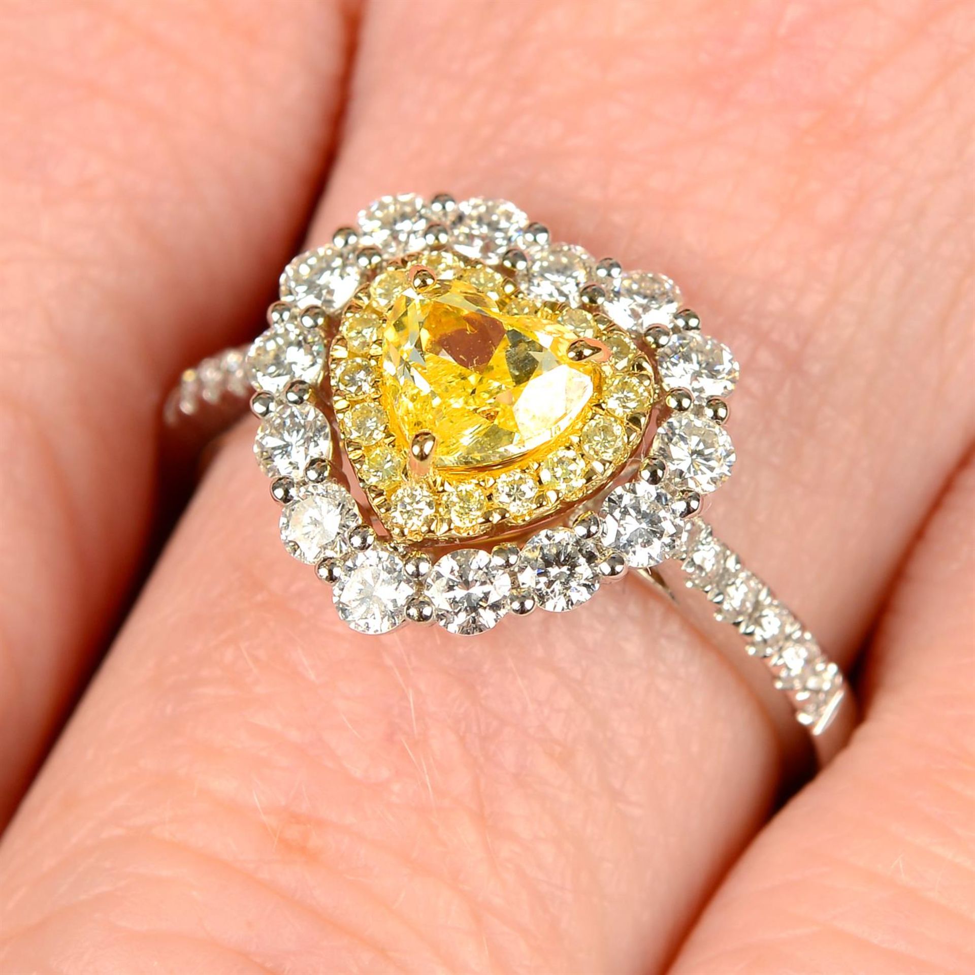 An 18ct gold Fancy Intense Yellow heart-shape diamond, 'yellow' diamond and diamond cluster ring.