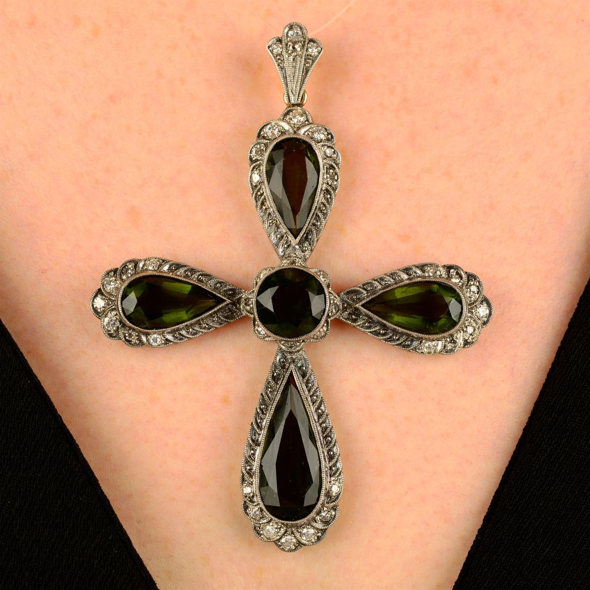 A moldavite and single-cut diamond cross pendant.