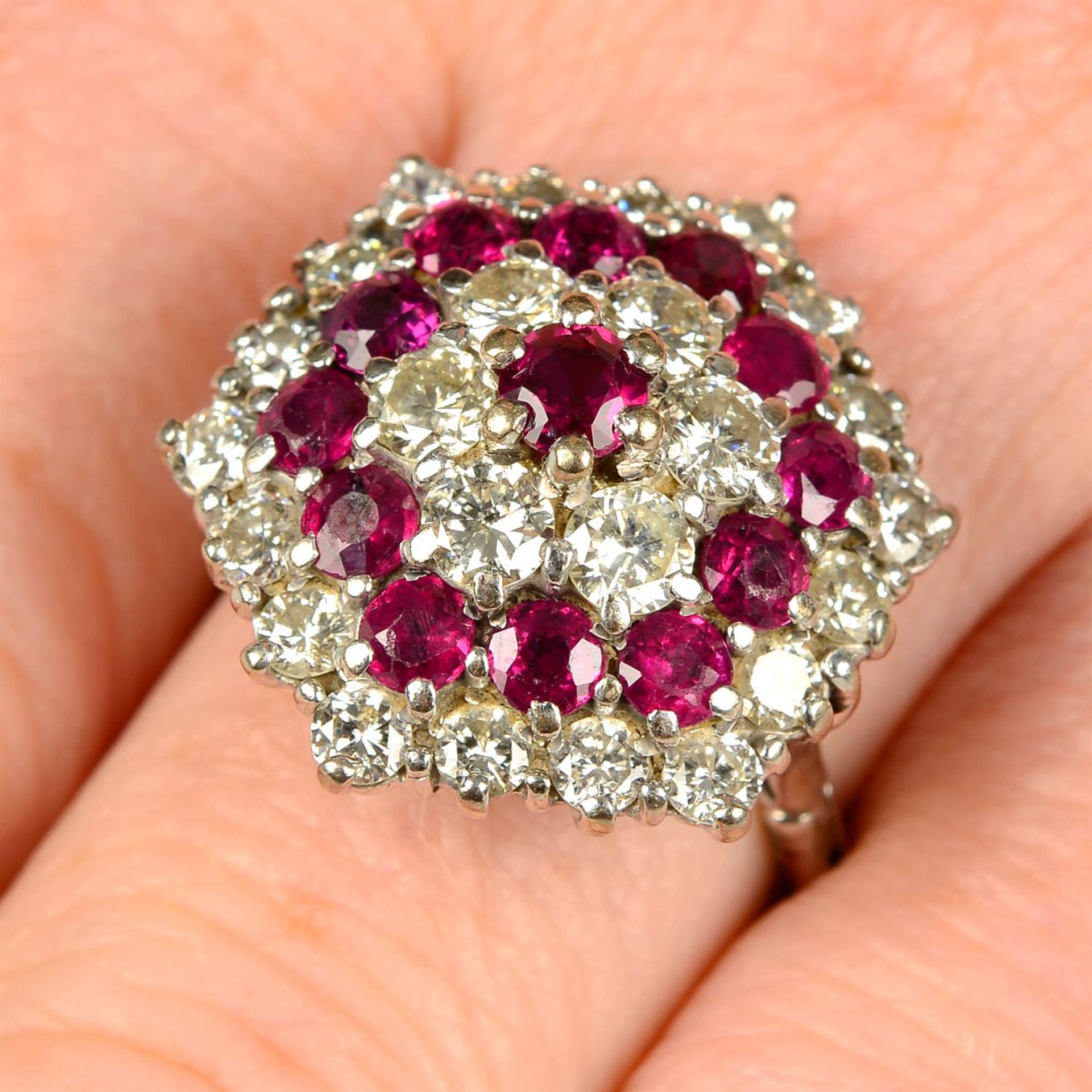 A brilliant-cut diamond and ruby cluster ring.