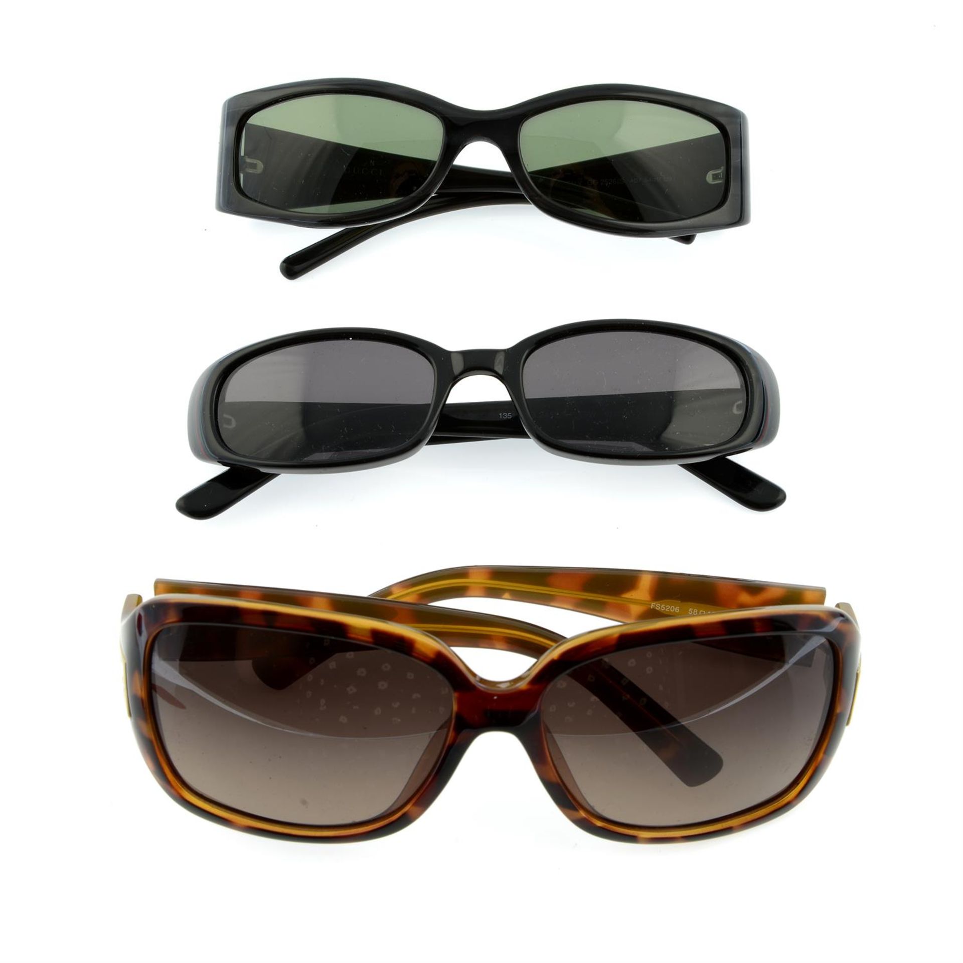 Three pairs of designer sunglasses.