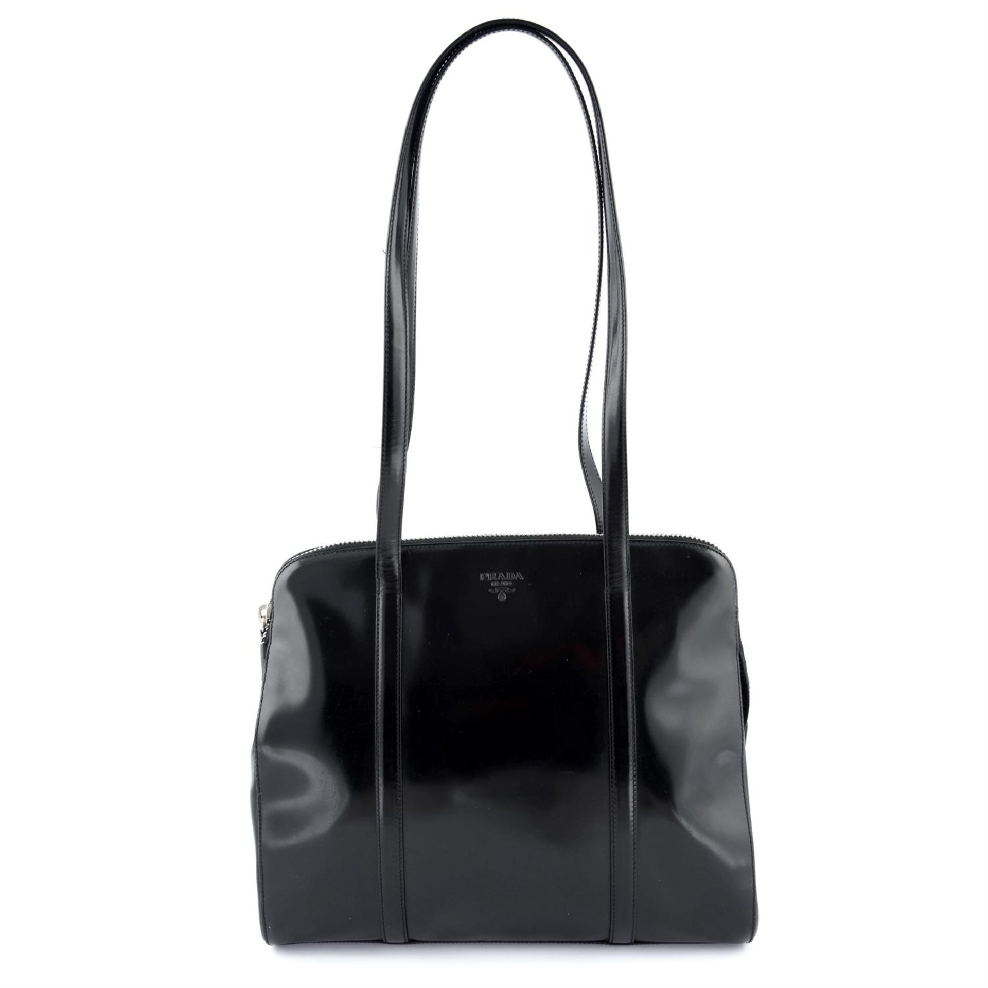 PRADA - a black patent leather shoulder bag.