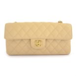 CHANEL - a cream caviar leather East West bag.