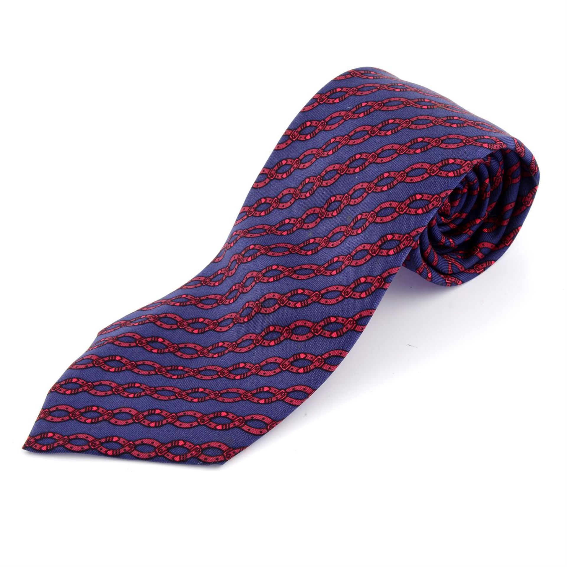 HERMÈS - a blue and red chain print silk tie.