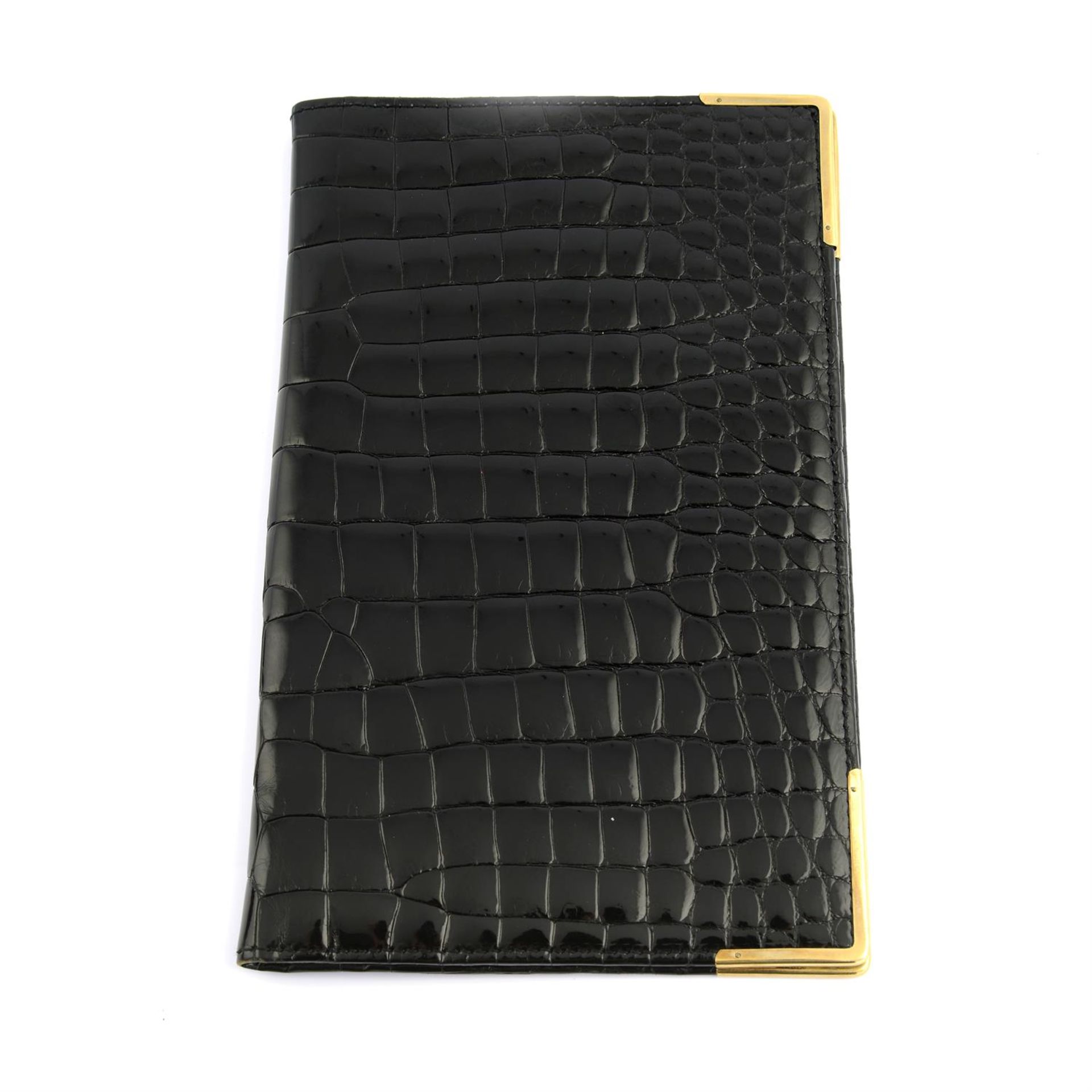 ASPREY - a black patent Crocodile leather wallet with 9ct gold mounted edges.