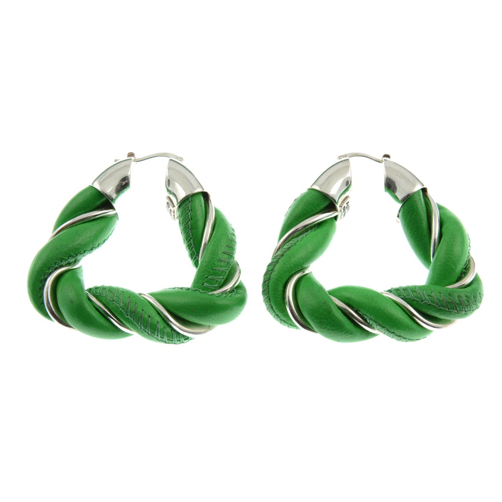 BOTTEGA VENETA - a pair of silver and green leather twisted hoop earrings.