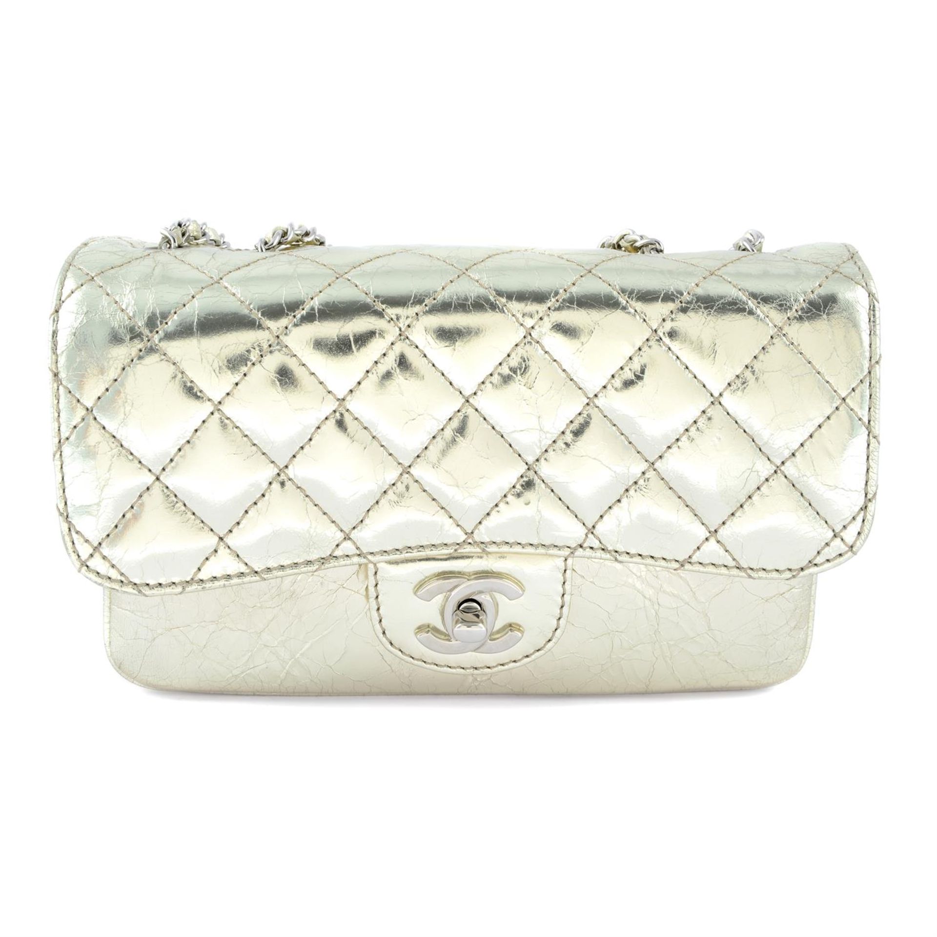 CHANEL - a metallic gold calfskin leather accordion flap handbag.