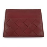 BOTTEGA VENETA - a burgundy leather card holder.