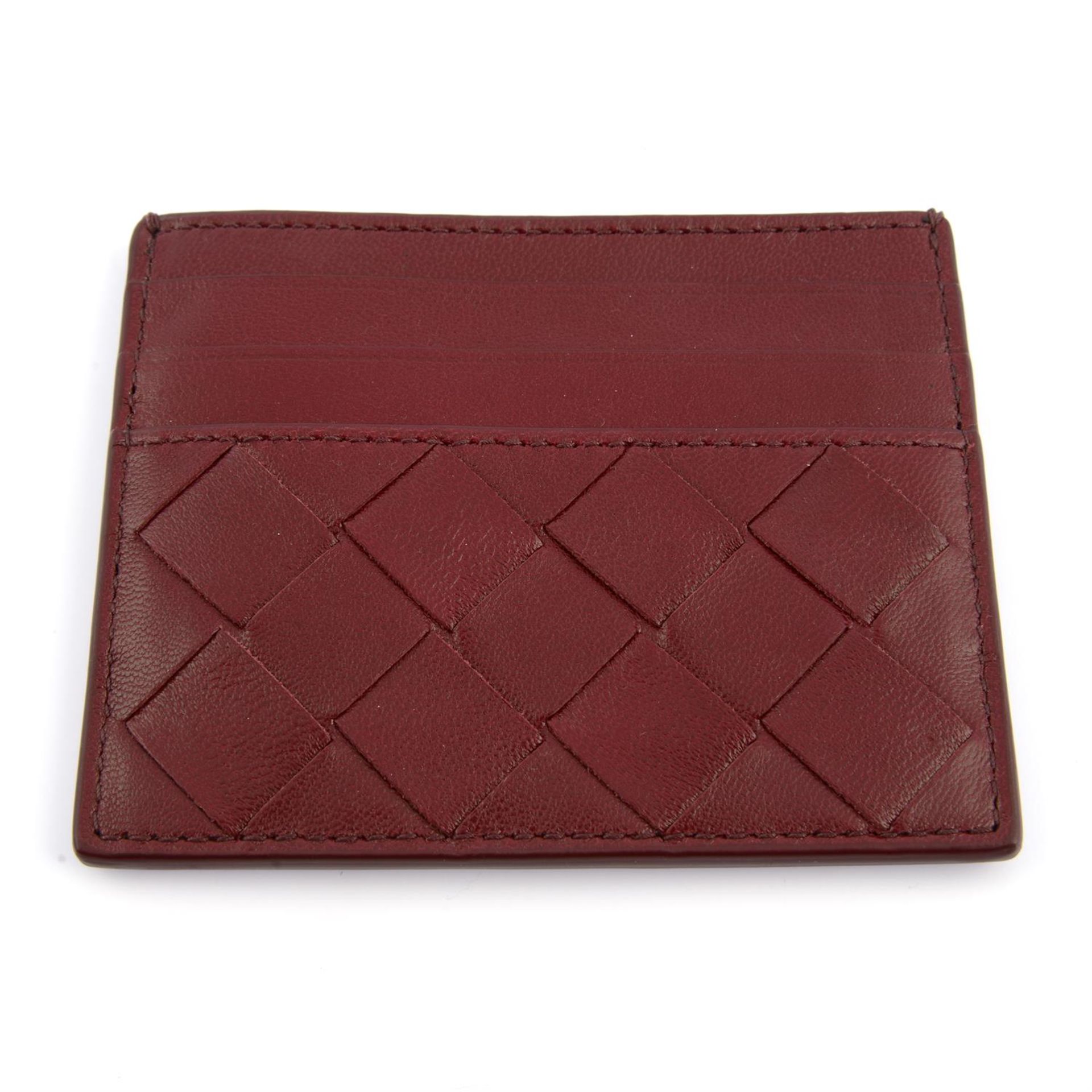 BOTTEGA VENETA - a burgundy leather card holder.