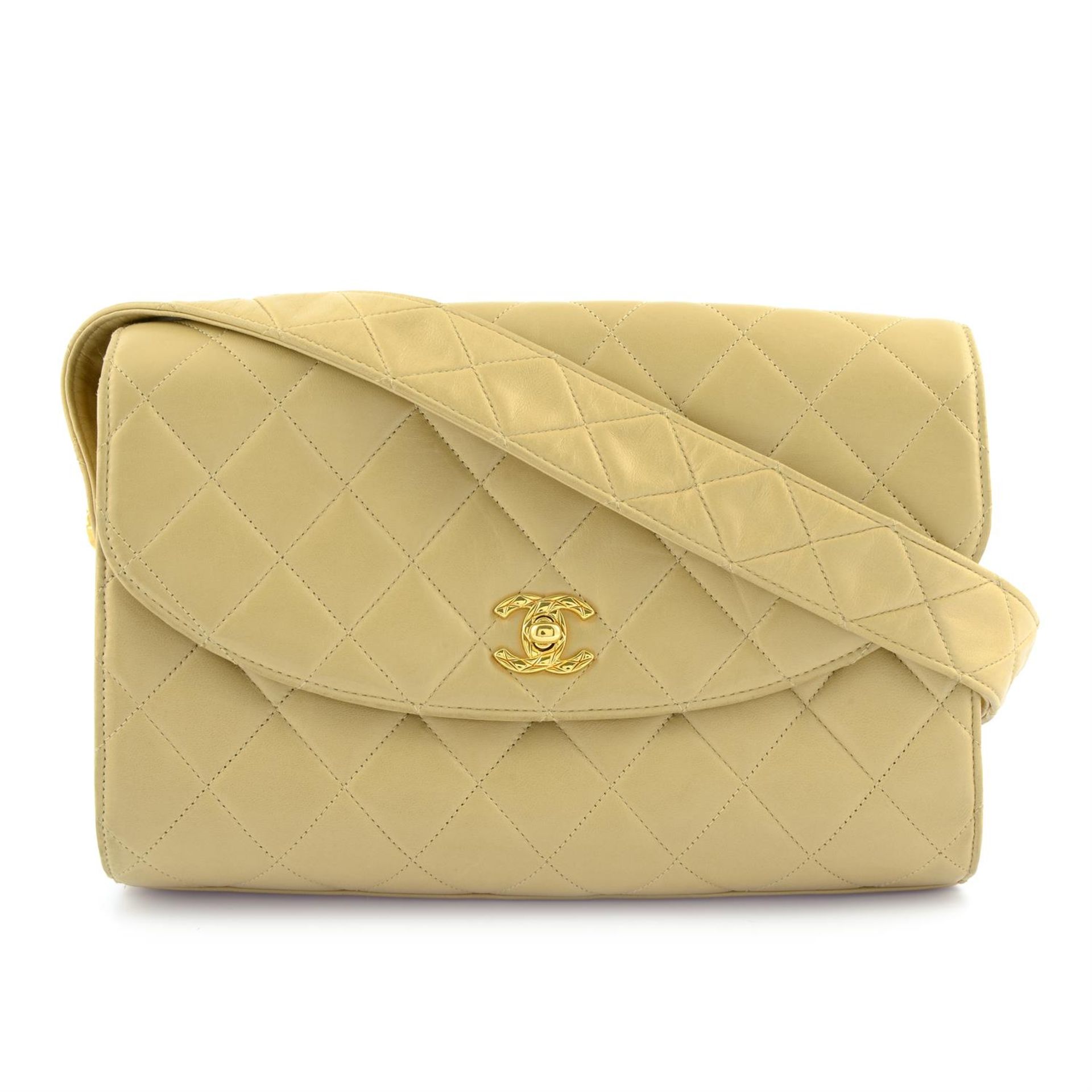 CHANEL - a beige lambskin leather handbag.