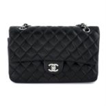 CHANEL - a medium black lambskin double flap bag.