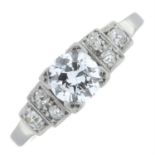 A mid 20th century platinum brilliant-cut diamond single-stone ring, with old-cut diamond shoulders.