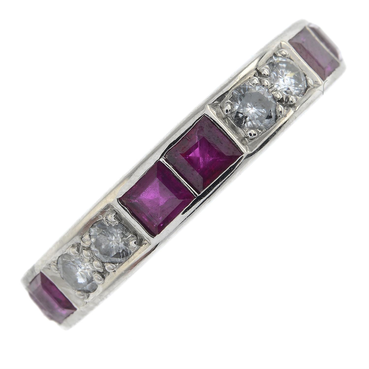 A ruby and diamond half eternity ring.