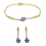 A vari-hue cubic zirconia bracelet, together with a pair of matching drop earrings.