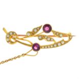 An early 20th century 15ct gold garnet and split pearl foliate brooch.