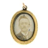 An early 20th century front and back glazed locket, with enamel border.